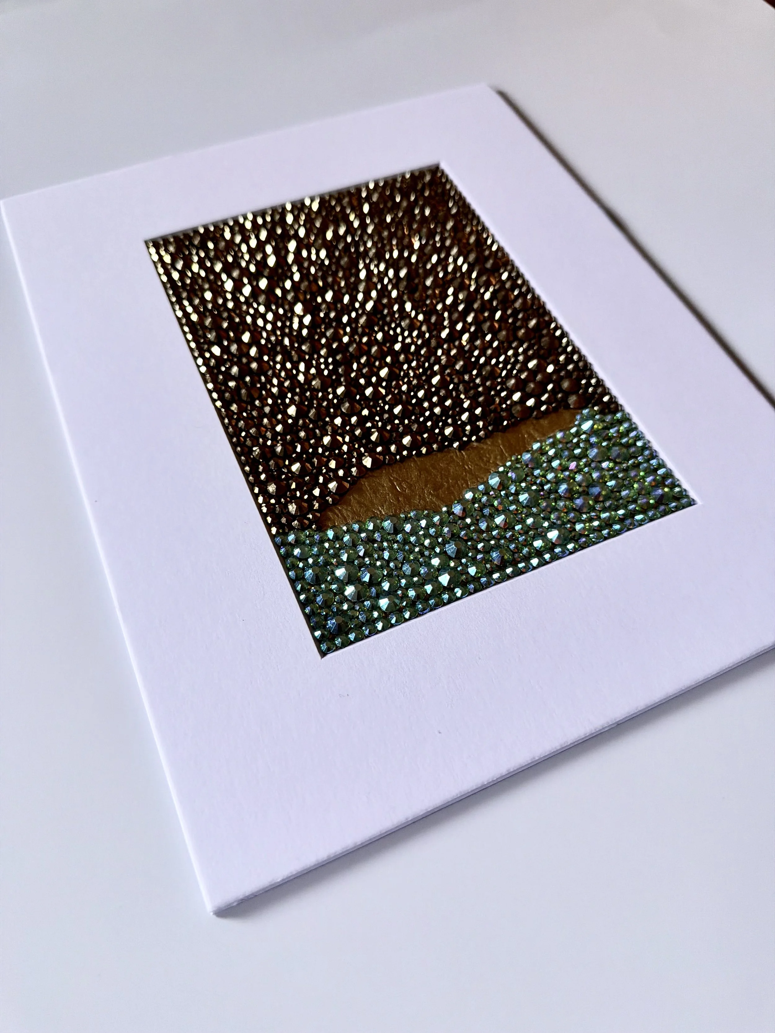 An angled close-up of the "Corrosion" paper study, showing the high-relief texture of the teal and gold rhinestone field.