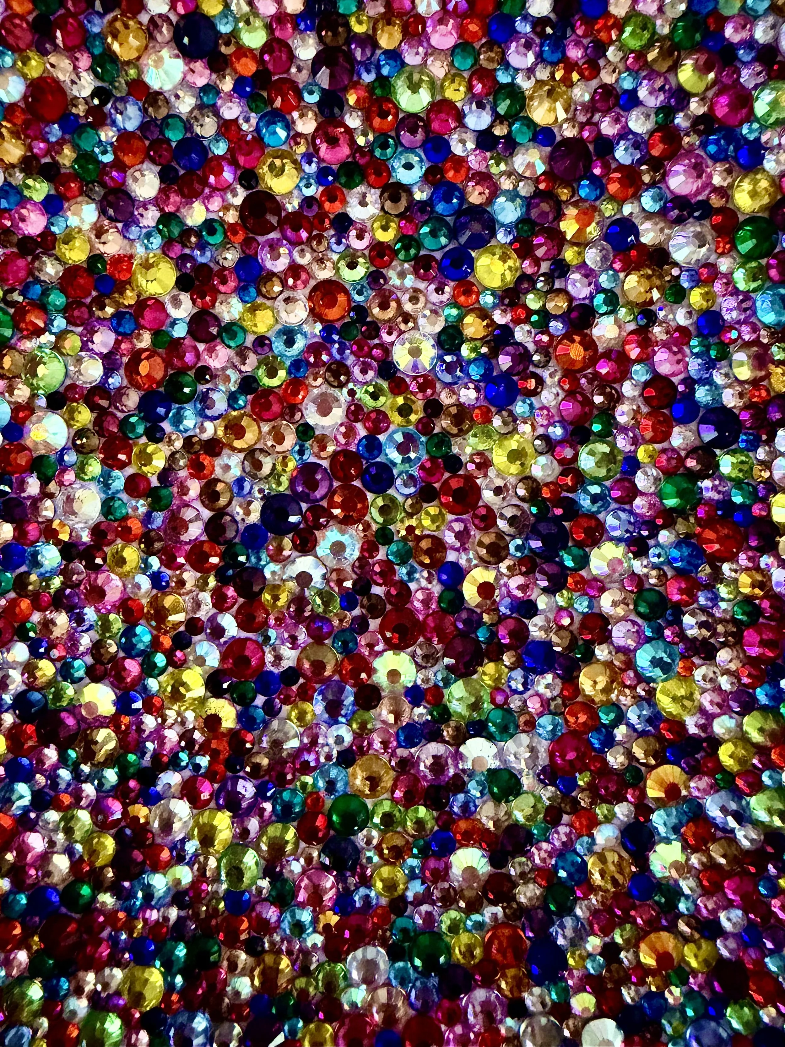 A vibrant, macro close-up of the "Frenzy" art piece, showcasing a dense and chaotic cluster of multi-sized, multicolor rhinestones.