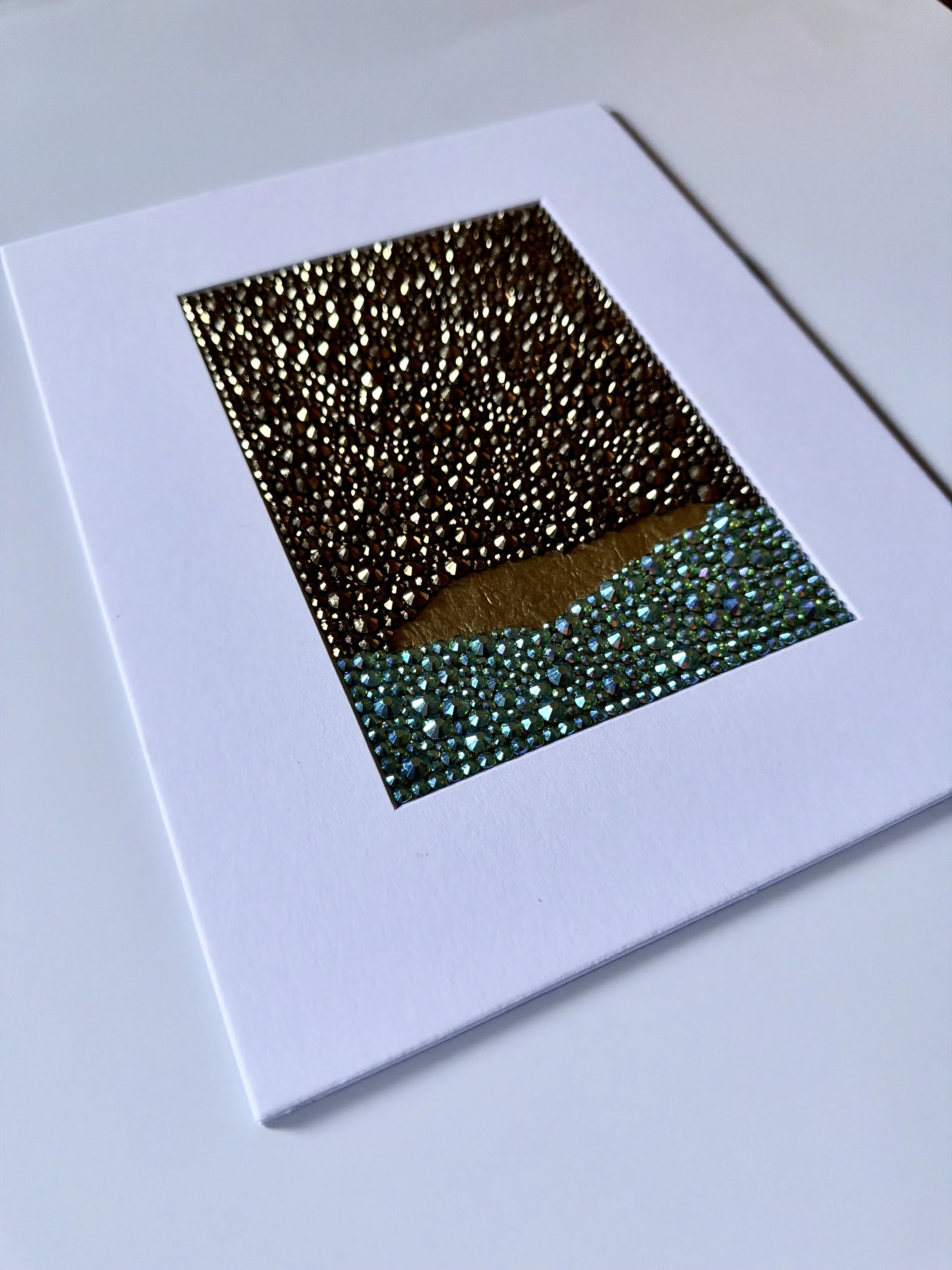 An angled close-up of the "Corrosion" paper study, showing the high-relief texture of the teal and gold rhinestone field.