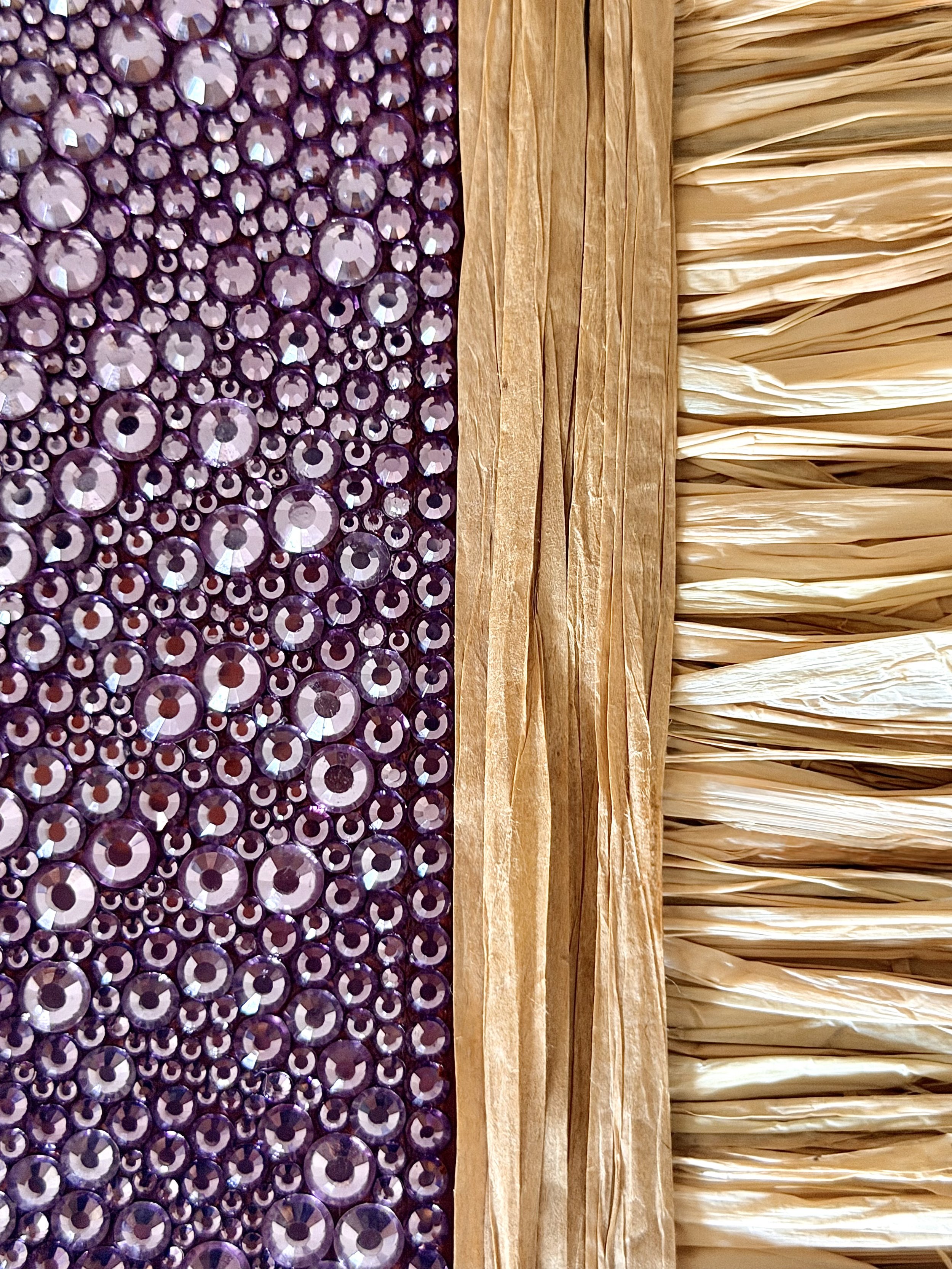 A macro close-up of the "Collapse" art piece, showcasing multi-sized mauve rhinestones and textured natural raffia.