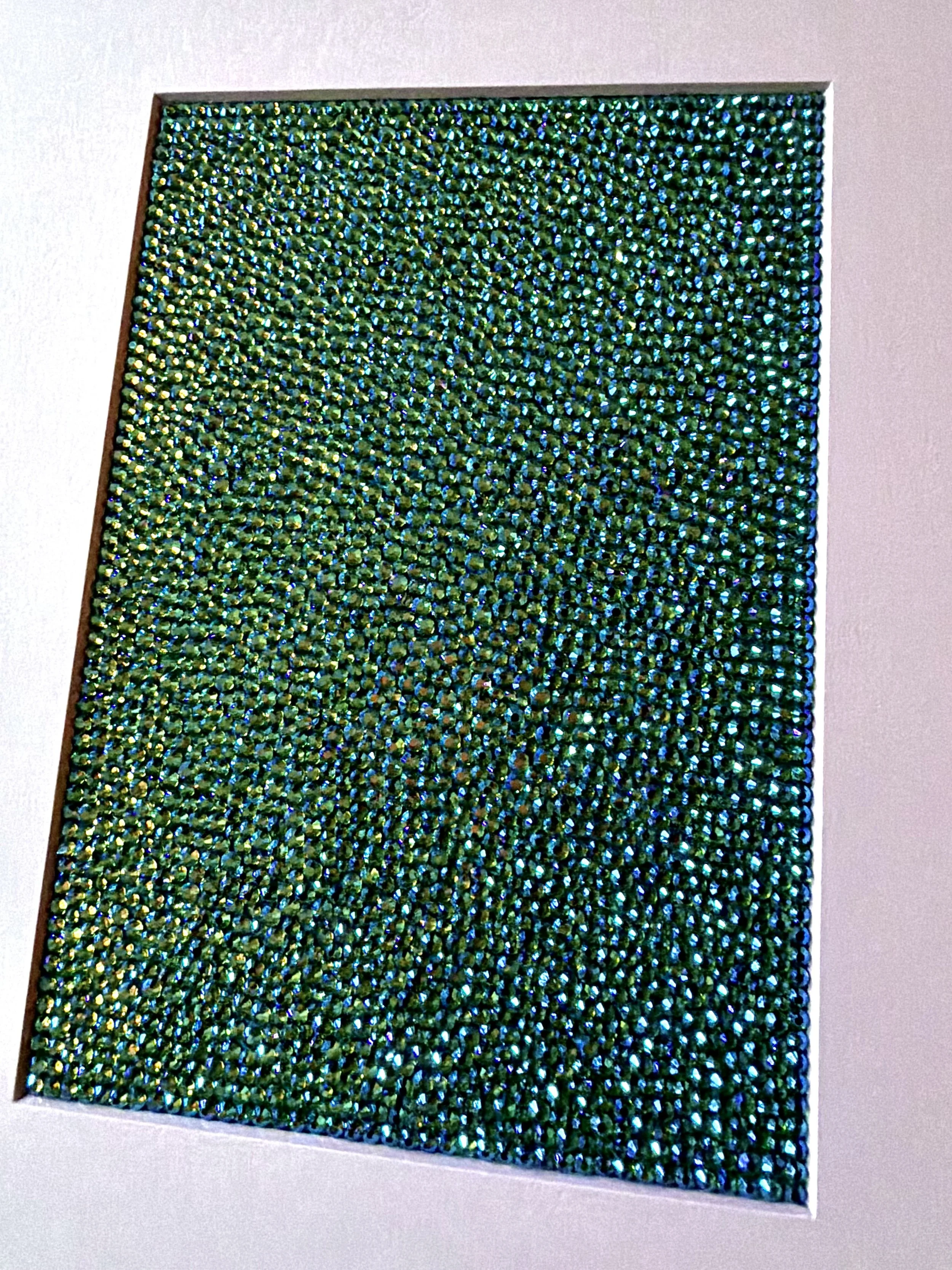 A macro detail shot of shimmering green and gold rhinestones catching the light on the "Hollow" original paper study.