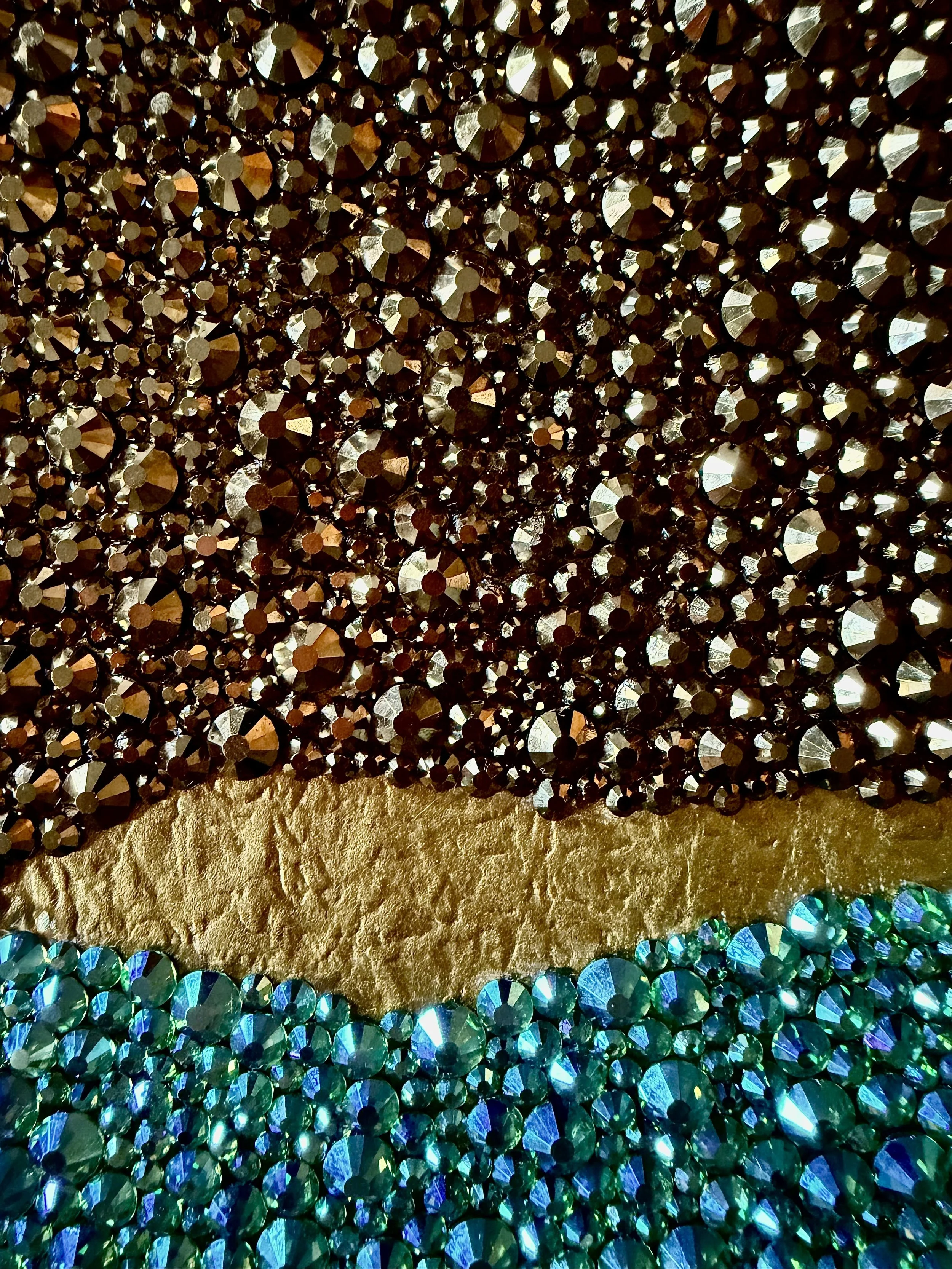 A macro detail shot of shimmering teal and gold rhinestones catching the light on the "Corrosion" original paper study.
