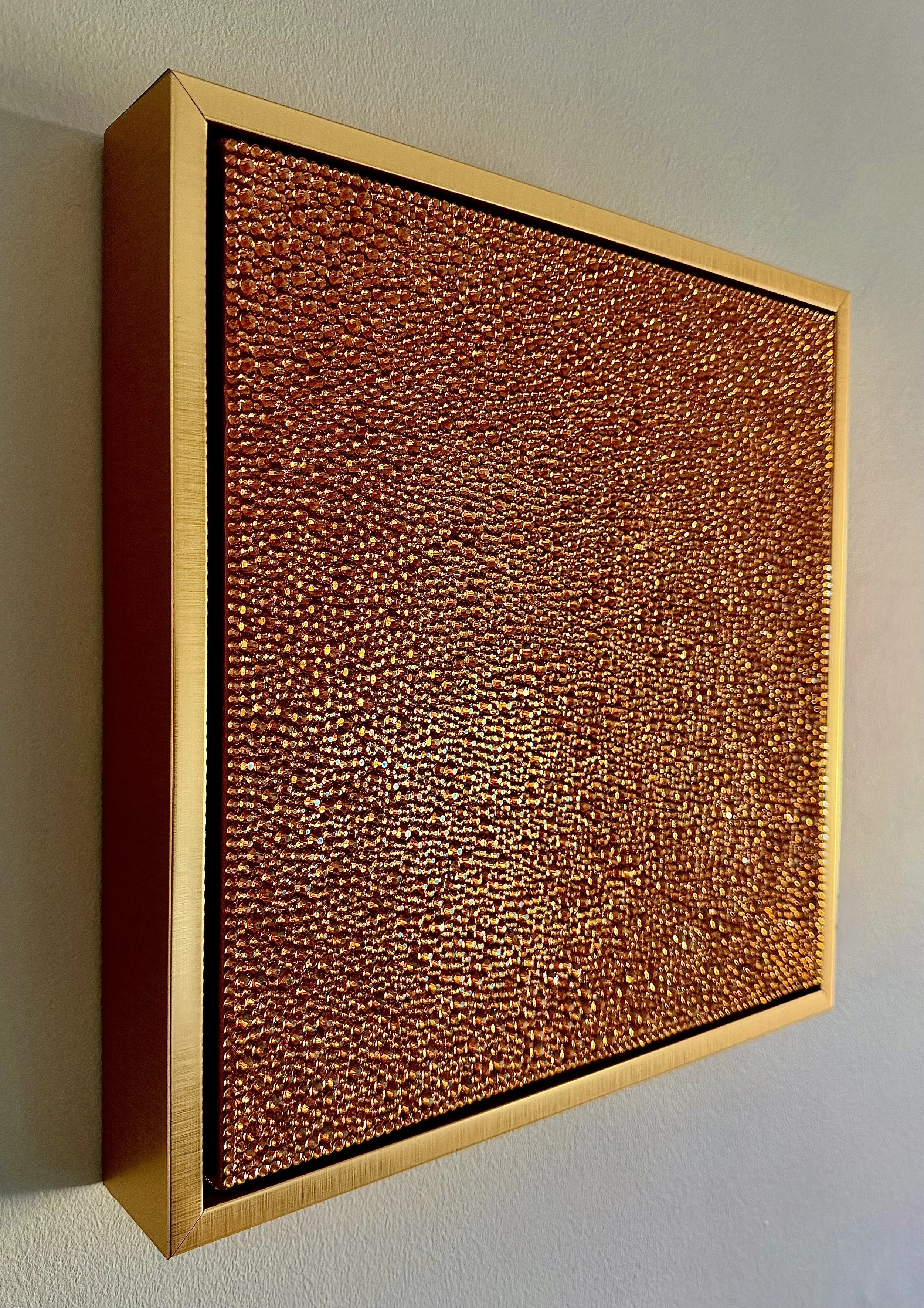 Side view of Gluttony (2026) showing the 3D depth of the amber rhinestones and the gold floating frame. Highlights the piece's sculptural profile.