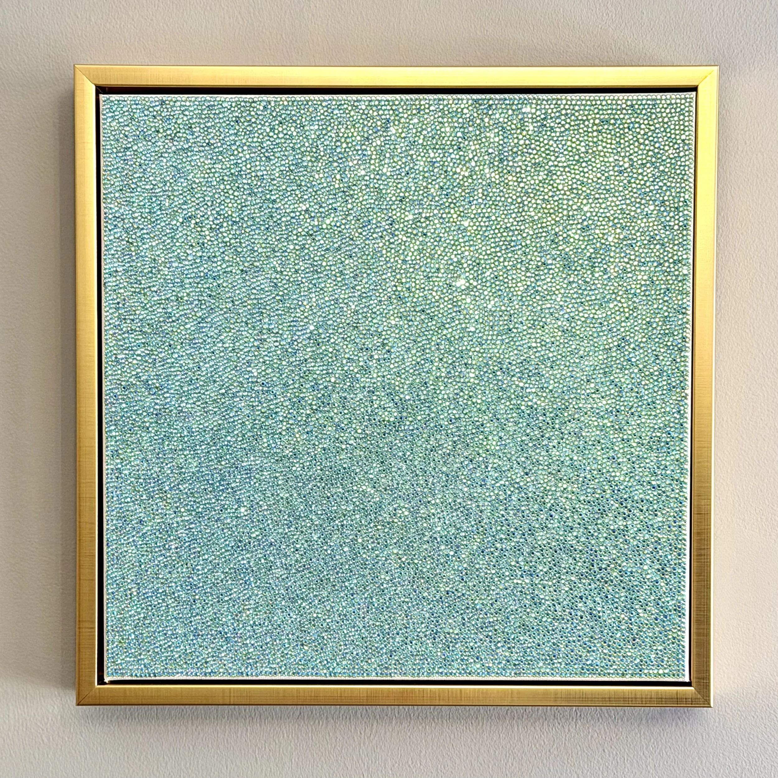 Devoid, 2025. 12 x 12 in. A monochromatic sculptural panel featuring hand-placed peridot glass rhinestones. The composition emphasizes raw texture and light reflection over color, creating a stark, crystalline surface.