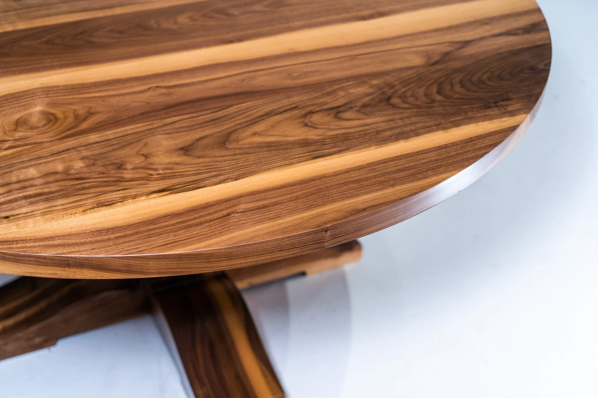 Close-up of a wooden table with a smooth, polished surface and natural wood grain patterns.