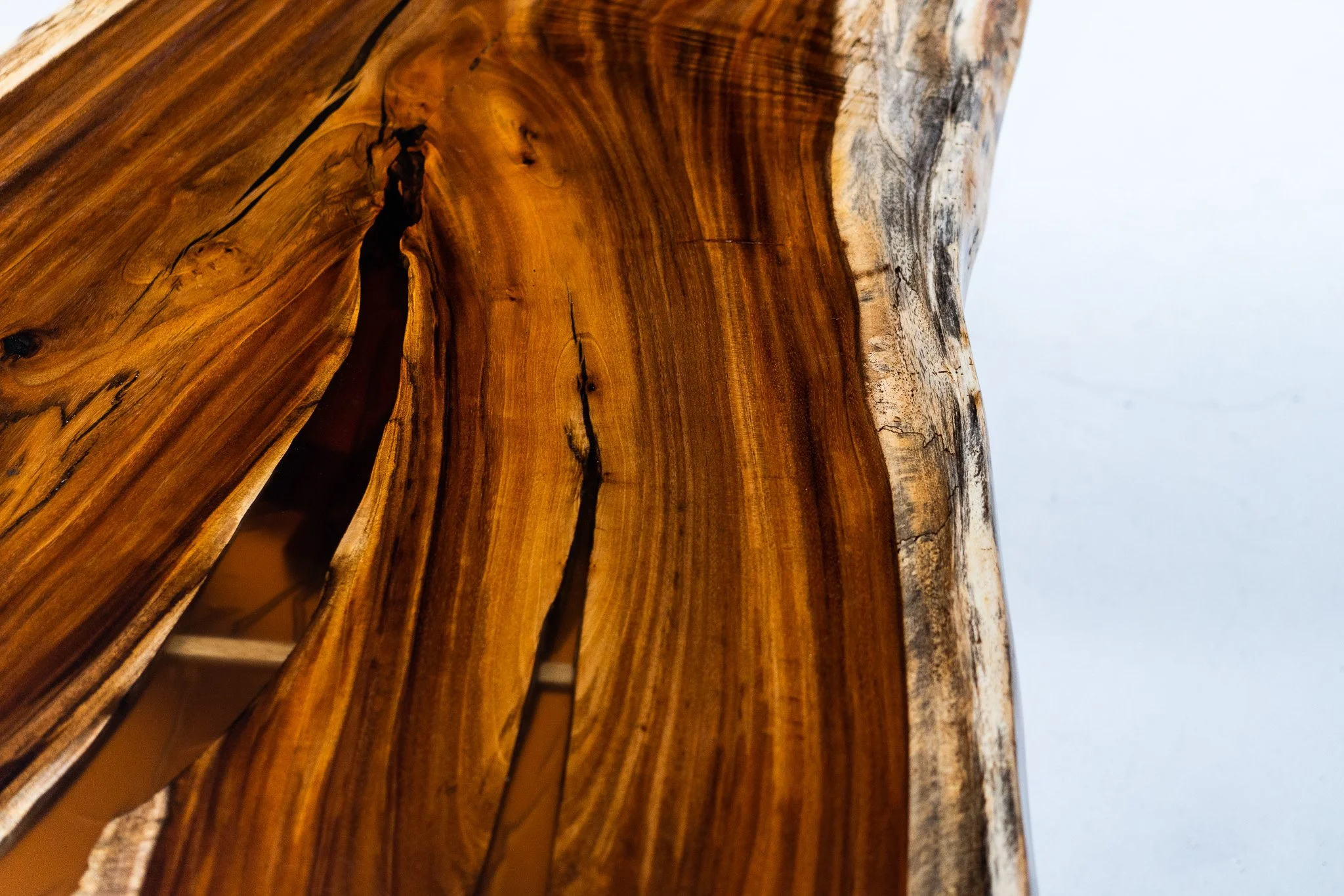 Close-up of a polished wooden surface displaying natural grain and color variations.