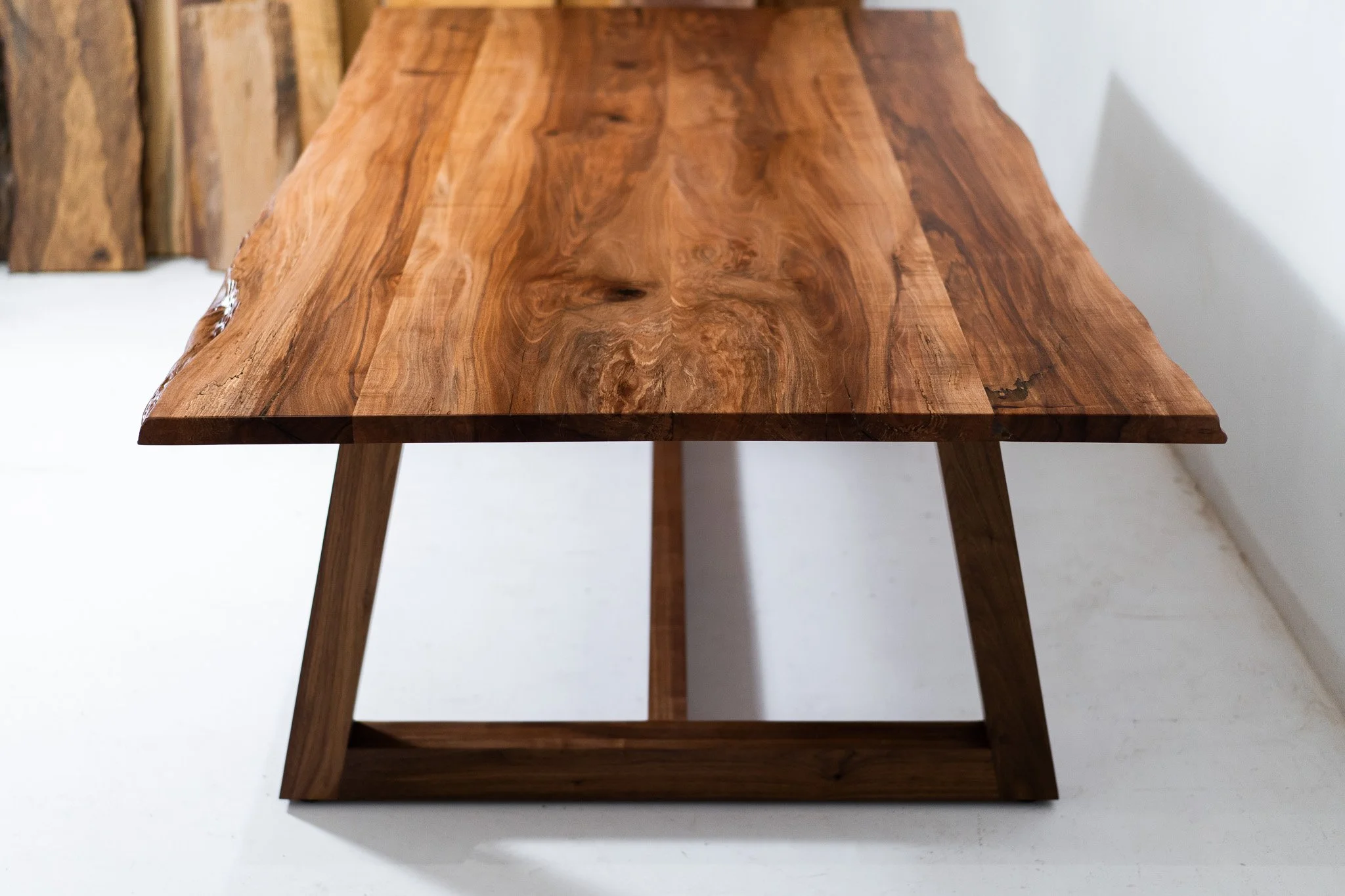A wooden table with a smooth, polished surface and angled legs.