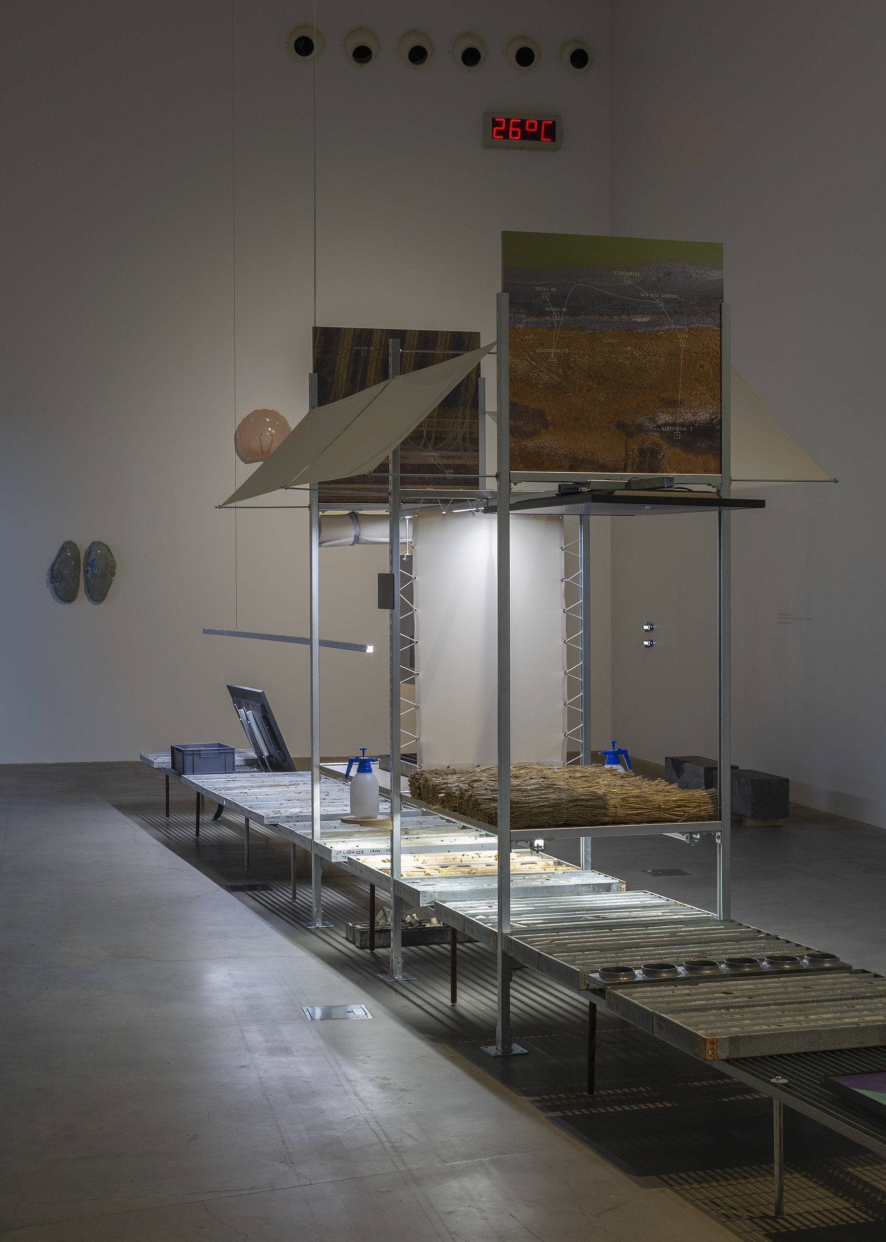 Installation view of works by Simulaa (foreground) and Alicia Frankovich (background), in Deep Time Real Time, RMIT Design Hub Gallery, Carlton, 2025. Photo by Christian Capurro.