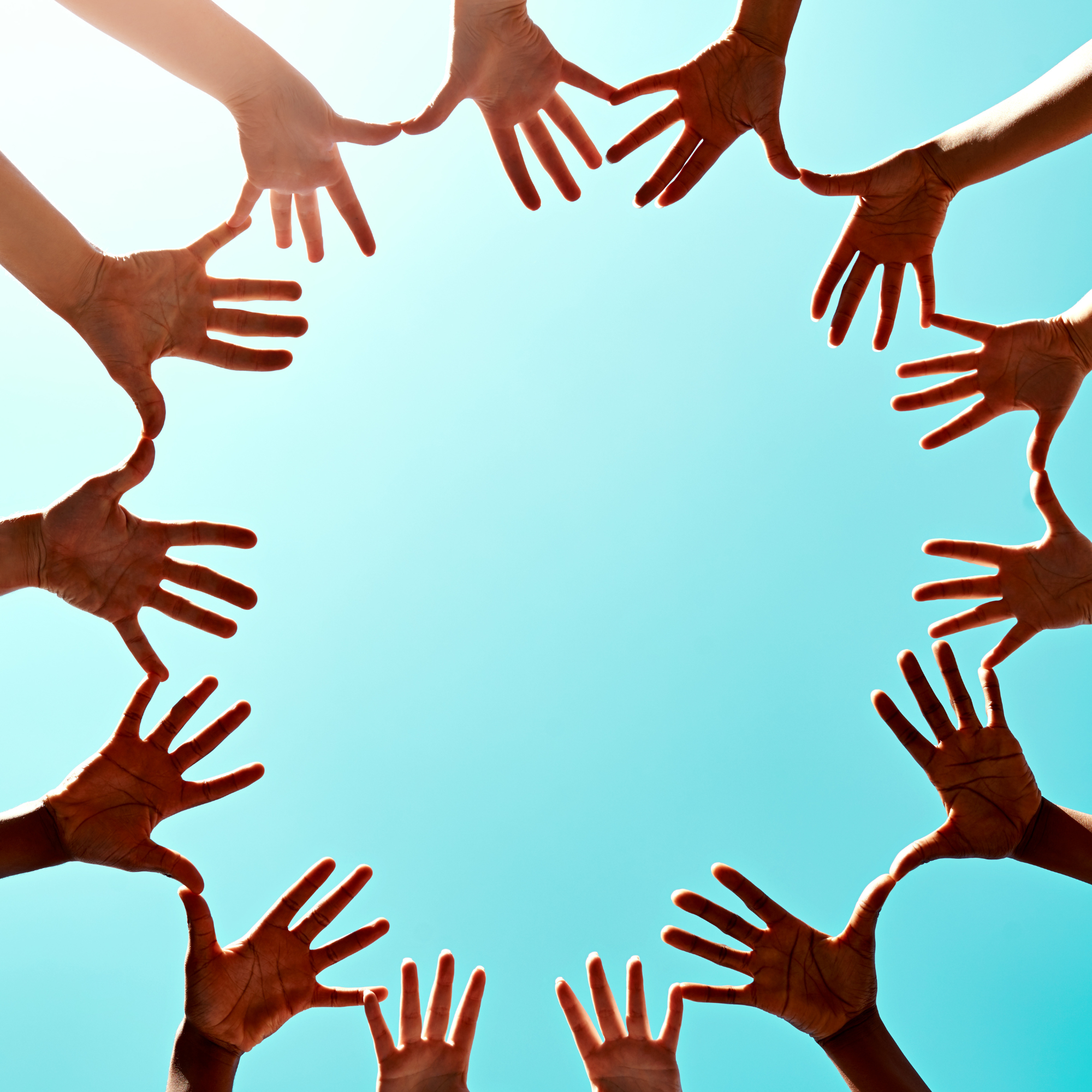 Multiple hands reaching toward the center, forming a circle against a blue sky.
