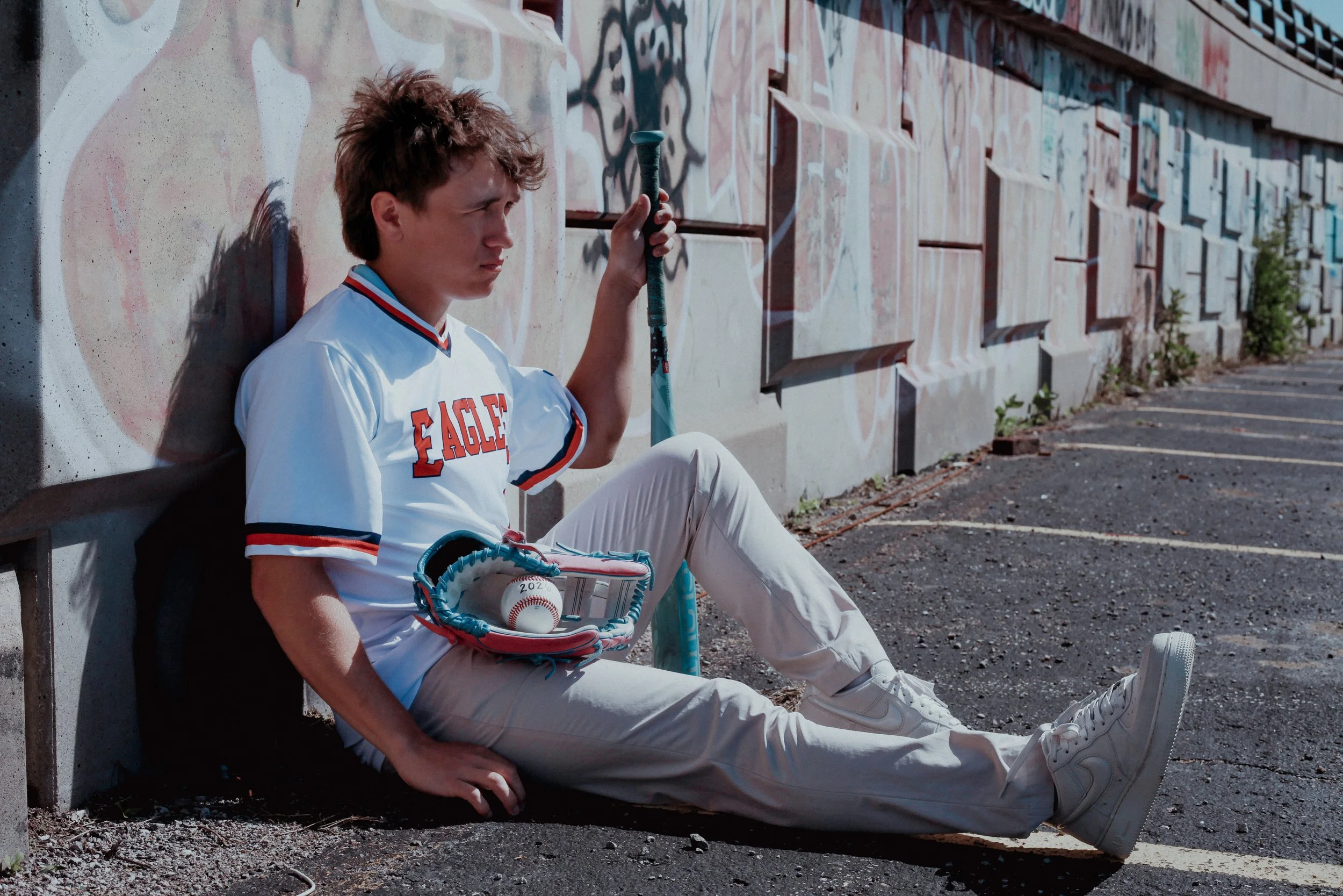 boy-senior-photo-kansas-city-mural-art-jersey-baseball-glove-bat-2026