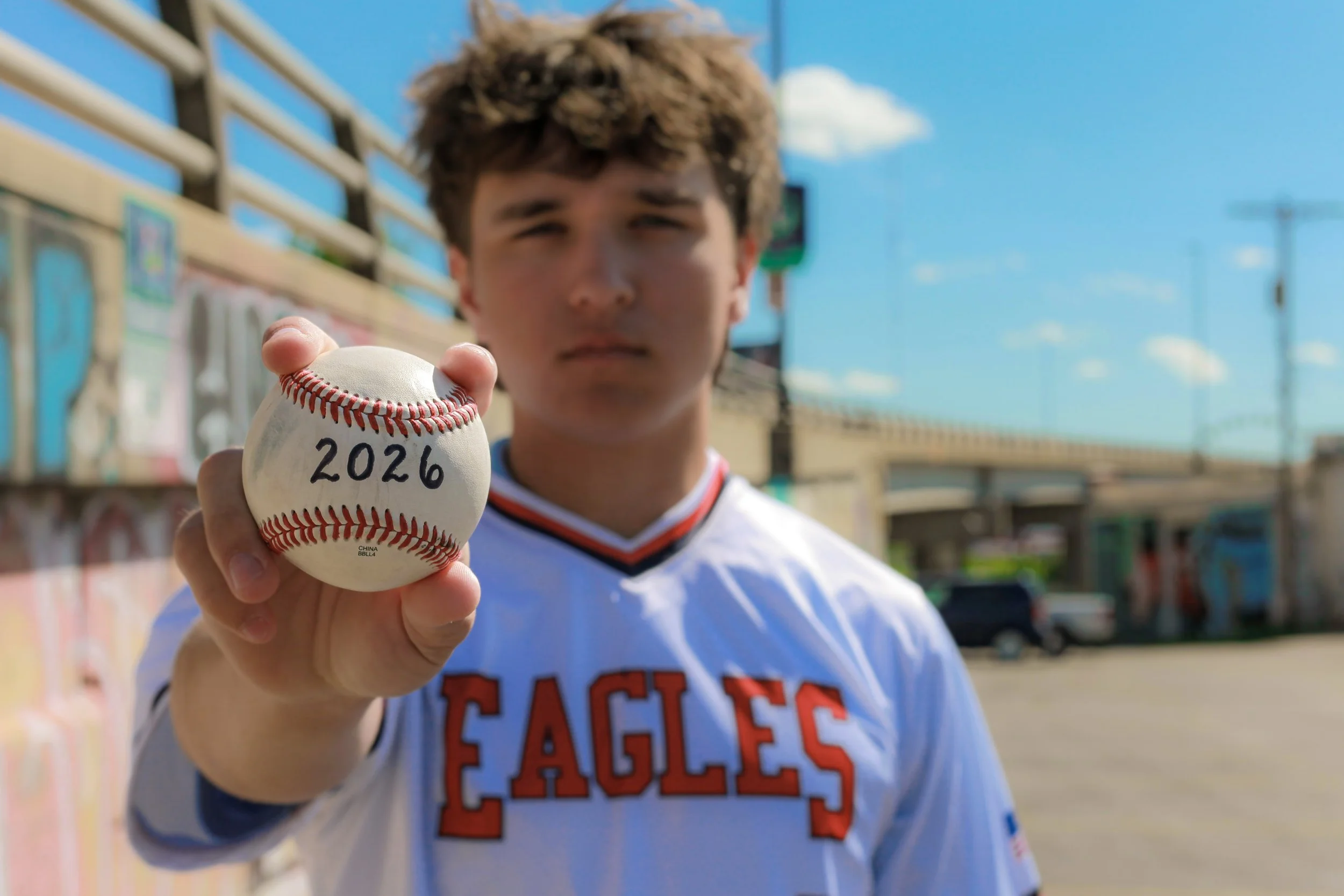 boy-senior-photo-kansas-city-mural-art-jersey-baseball-2026