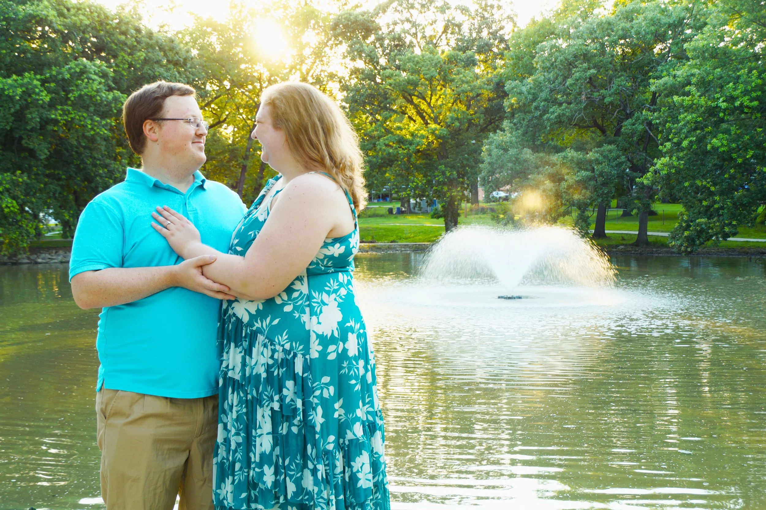 engagement-rings-lake-happy-couple-nature-fountain-trees