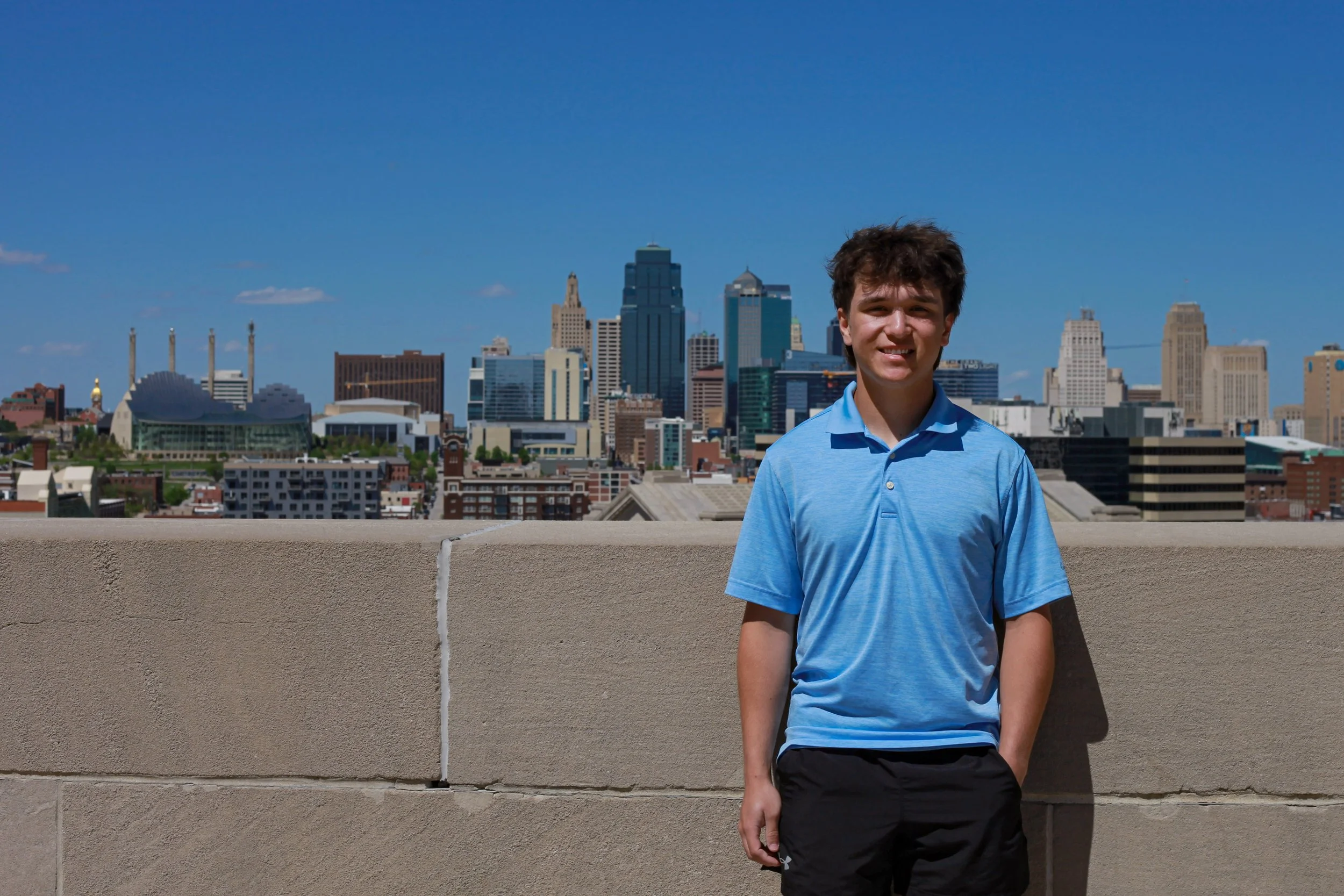 boy-senior-photo-kansas-city-WWI-museum-skyline-blue