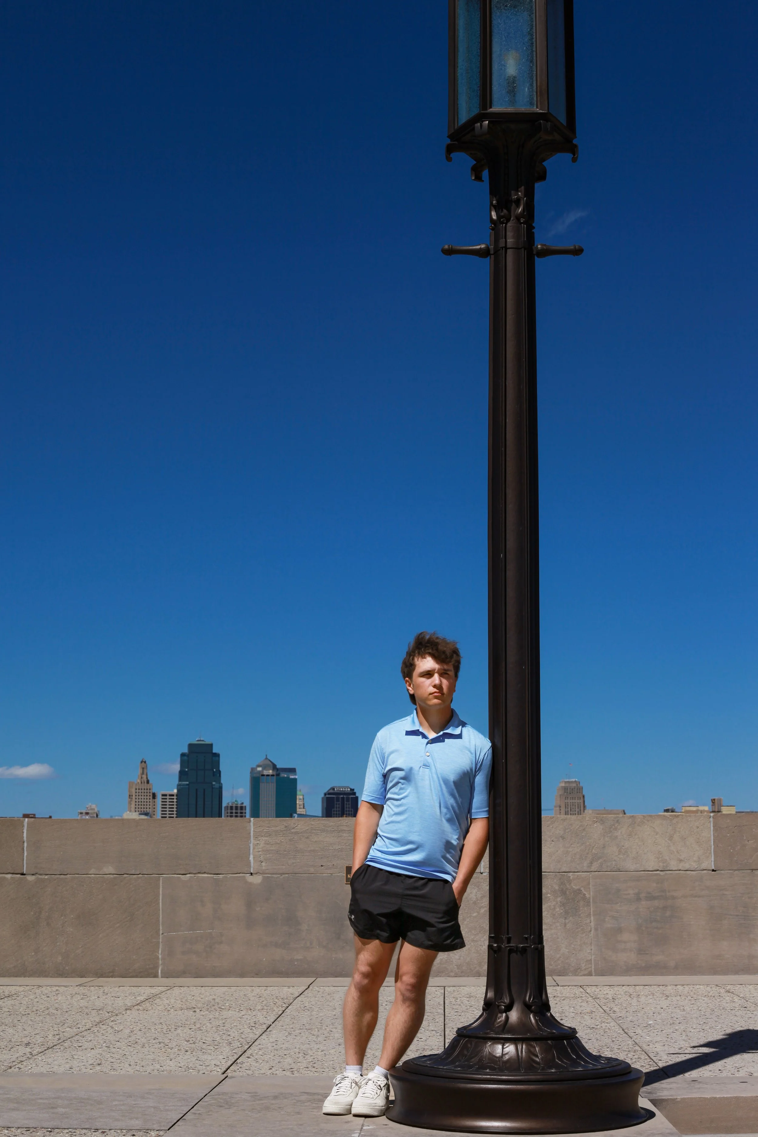 boy-senior-photo-kansas-city-WWI-museum-skyline-blue