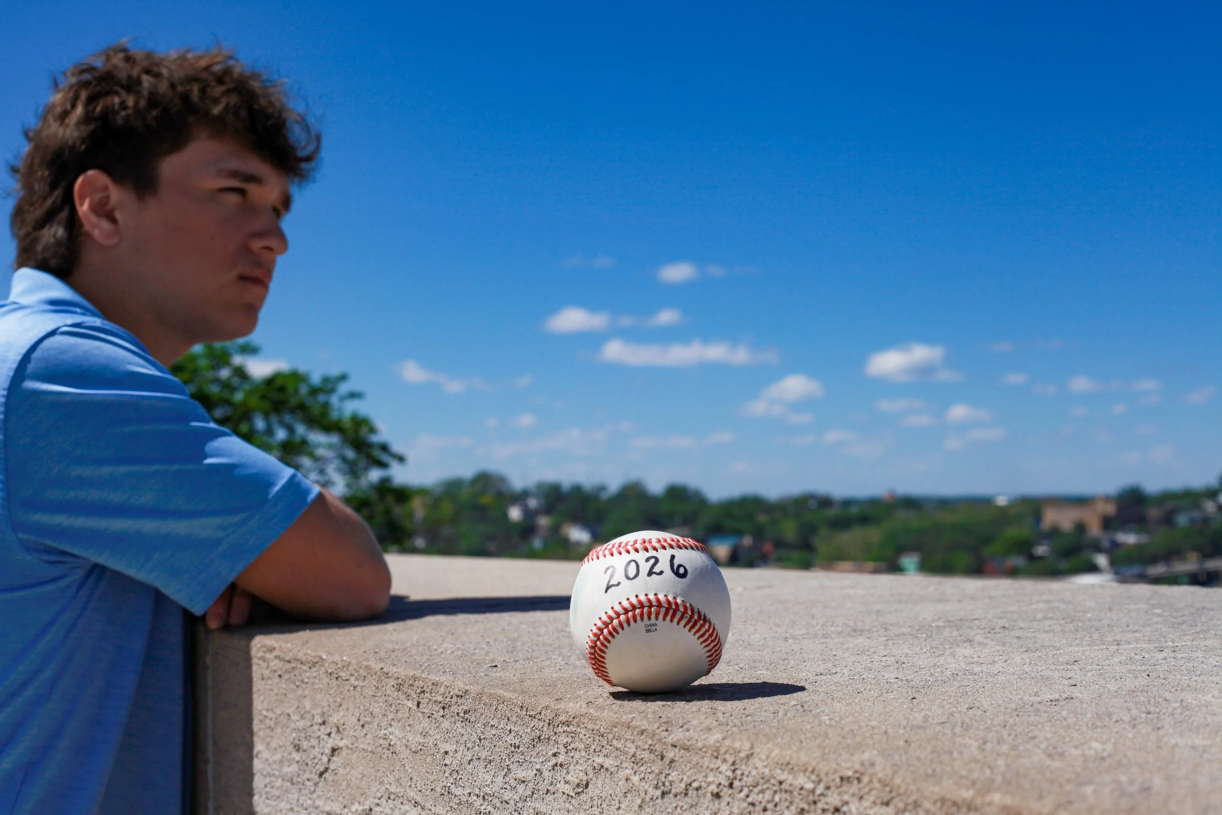 boy-senior-photo-kansas-city-WWI-museum-skyline-blue-baseball-2026
