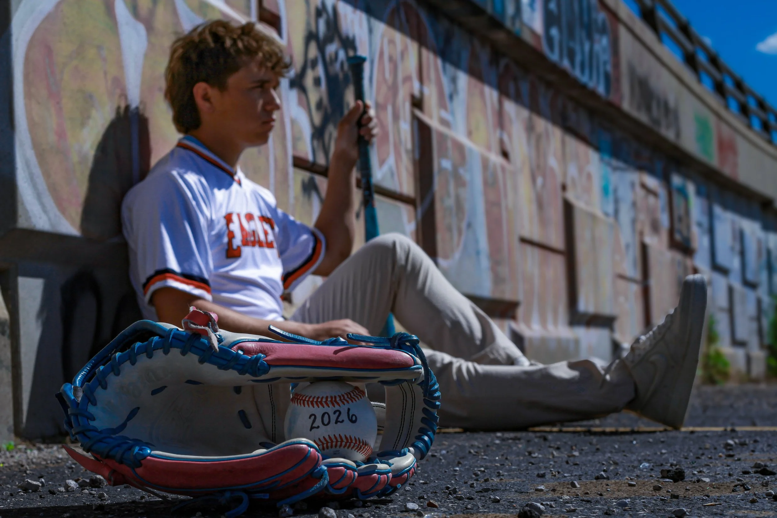 boy-senior-photo-kansas-city-mural-art-jersey-baseball-glove-bat-2026