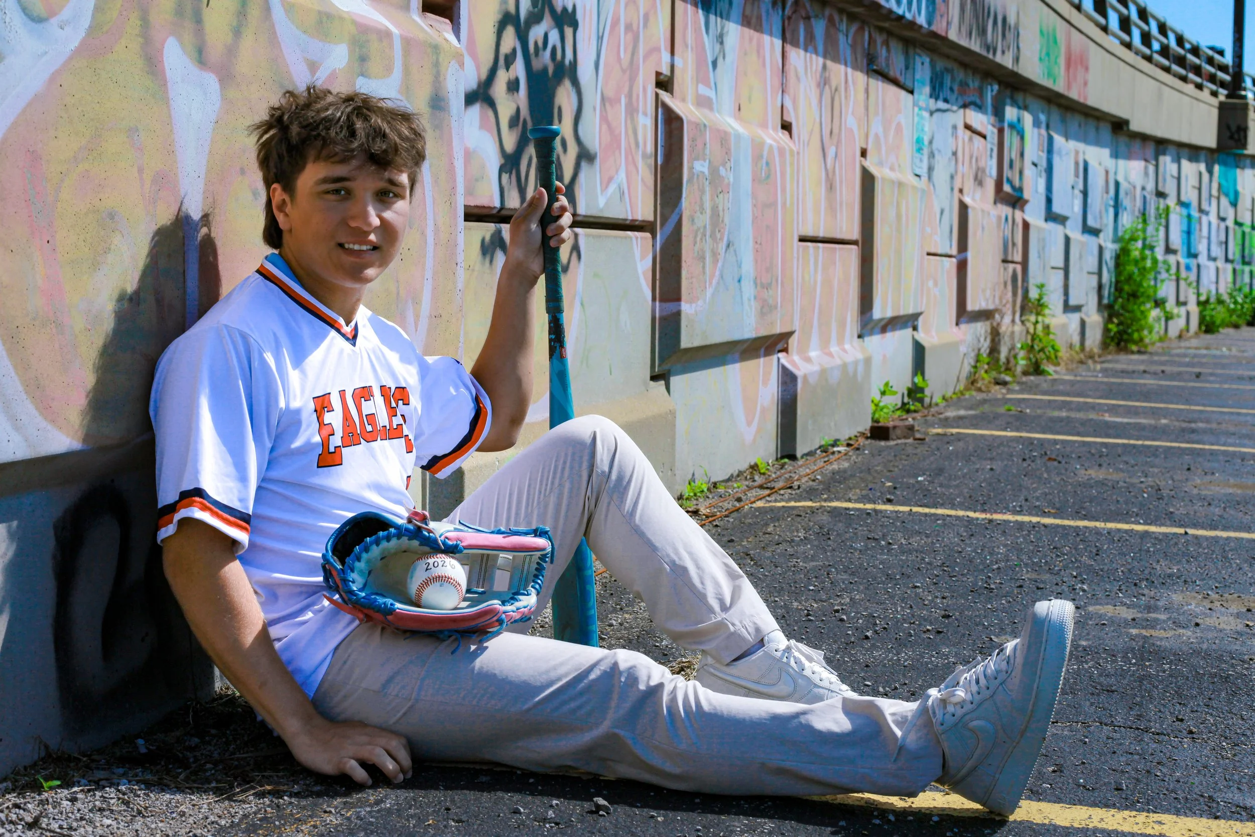 boy-senior-photo-kansas-city-mural-art-jersey-baseball-glove-bat-2026