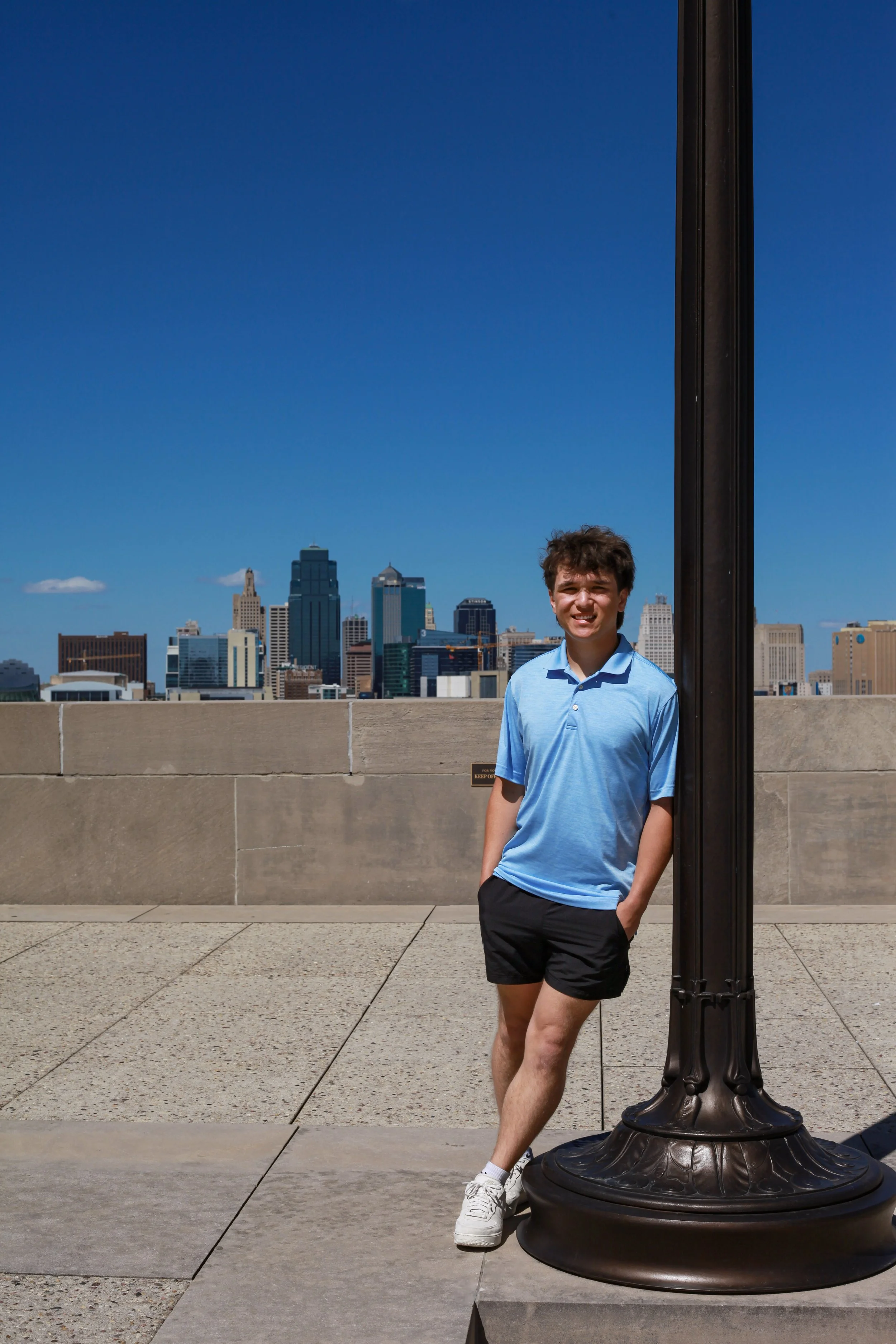 boy-senior-photo-kansas-city-WWI-museum-skyline-blue