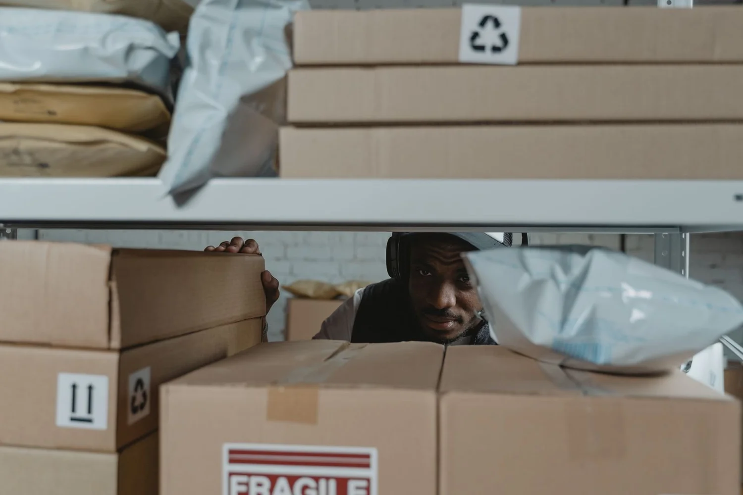 Worker inspecting parcels in a warehouse