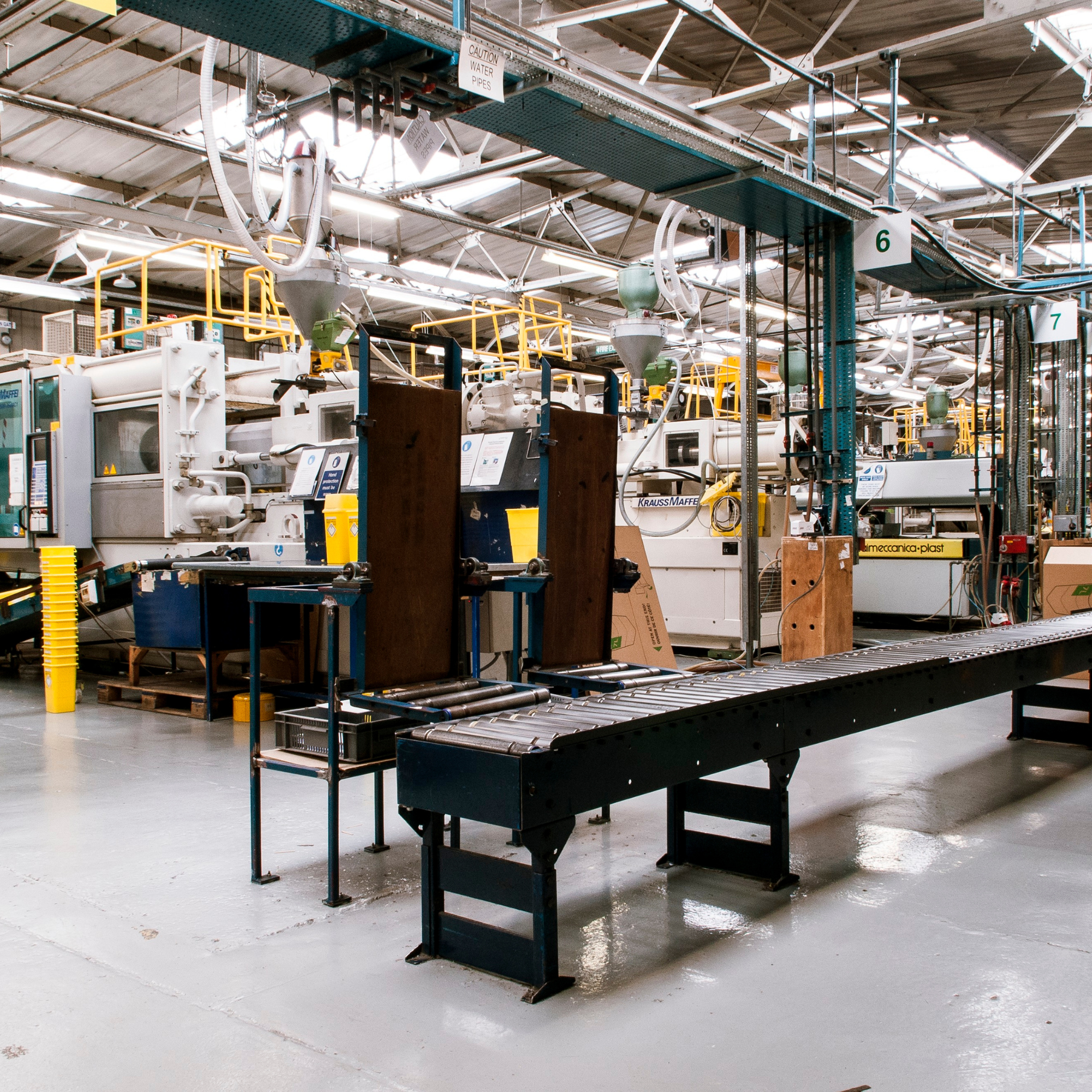 Industrial manufacturing facility with machinery, conveyor system, and production equipment.