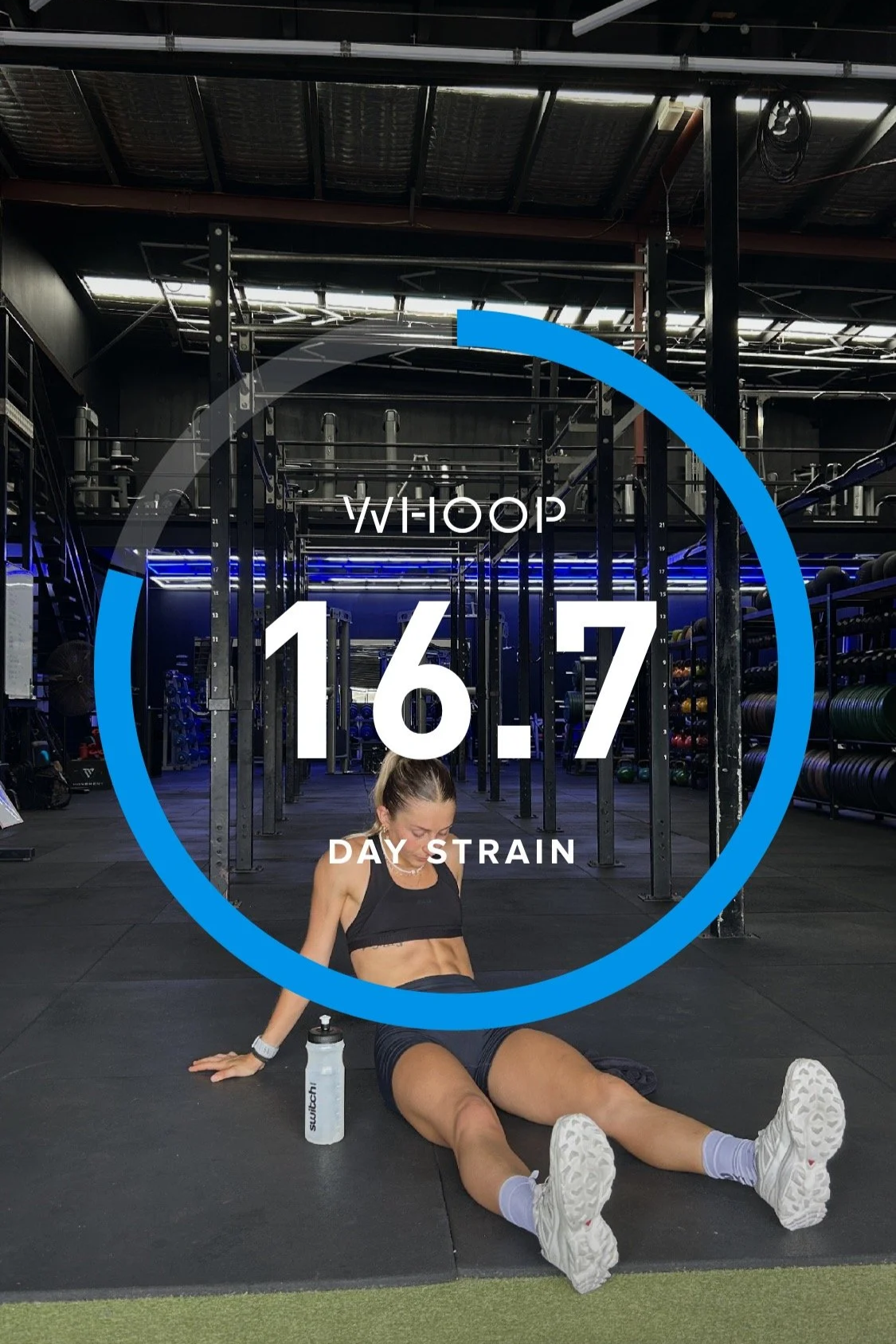 A woman sitting on the gym floor after workout with water bottle, in front of fitness equipment in a gym, with a digital overlay showing the date 16.7, weekday 'Thursday', and 'Day 7' of a training program.