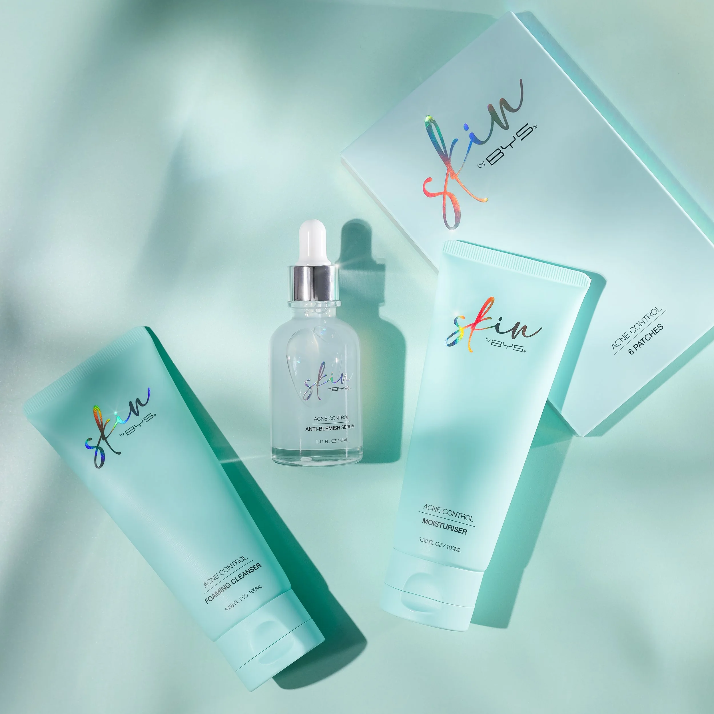 A collection of skincare products, including a serum, cleanser, foam, moisture, and acne control cream, displayed on a light surface with a mint green background.