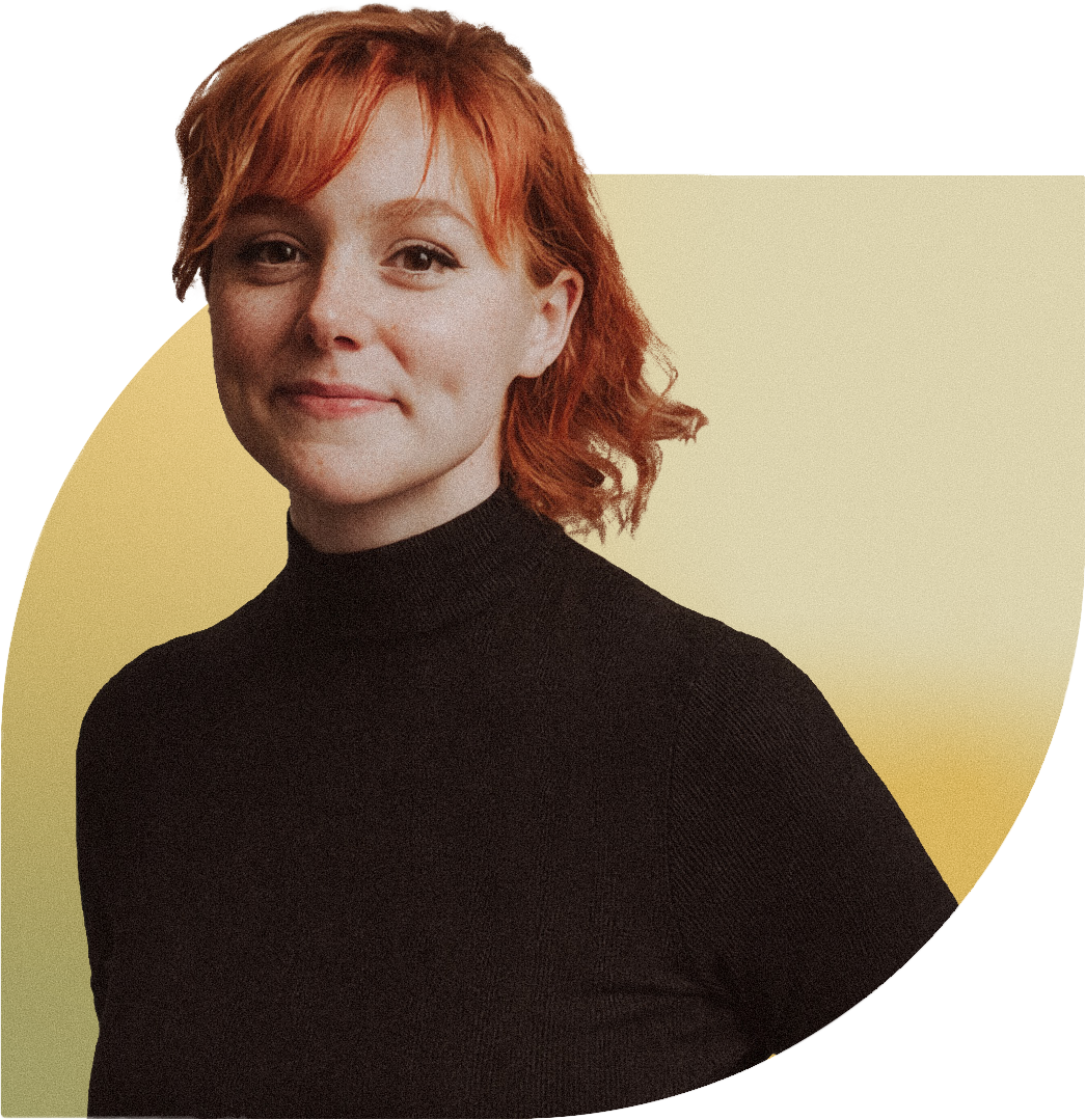 A photo of Emily, smiling with her red hair pulled back. She is partially obscured by a yellow background shape.