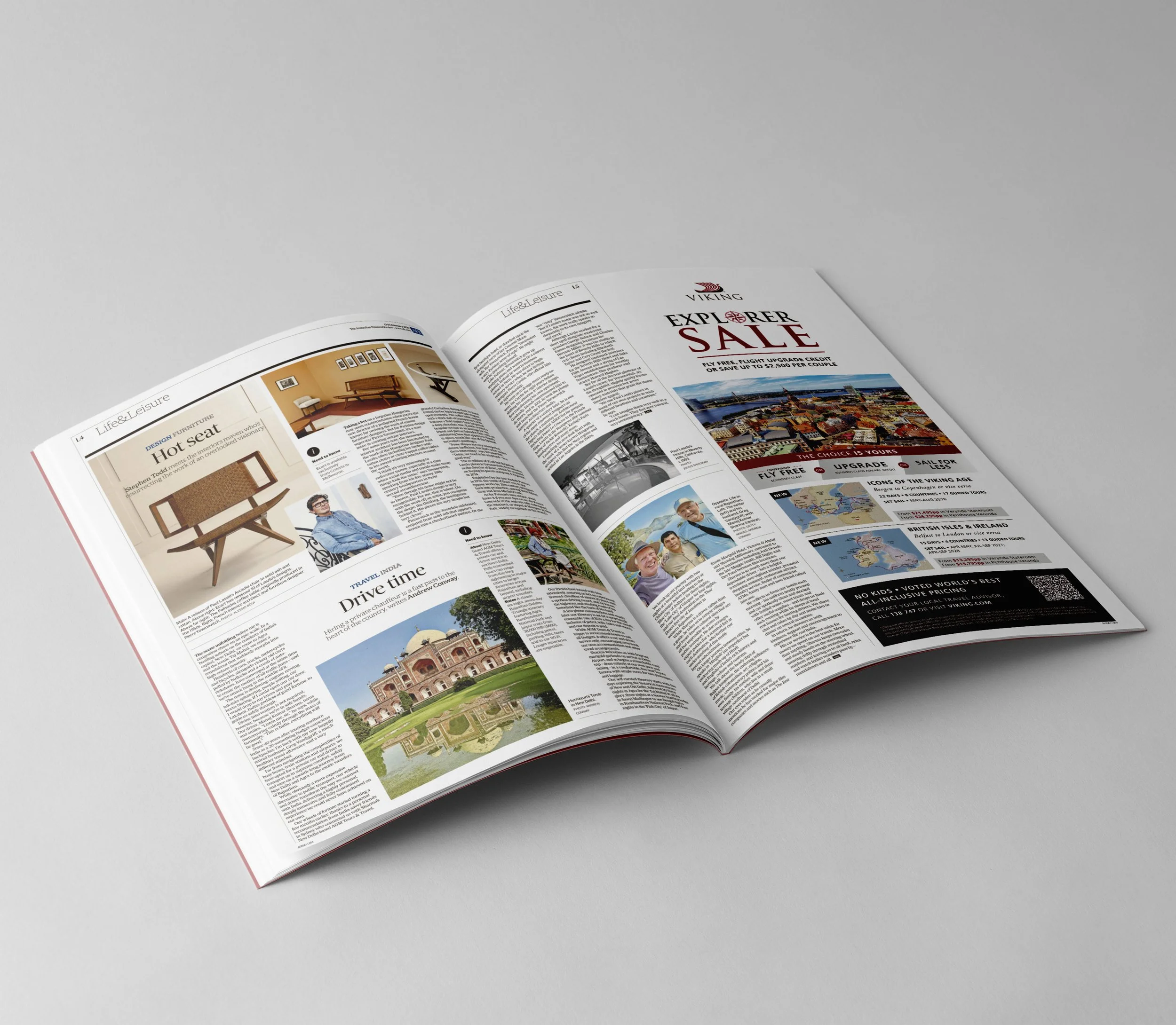 Open magazine on a gray surface, displaying articles and images related to travel and exploration, including a picture of a city with a bridge and other travel-related content.