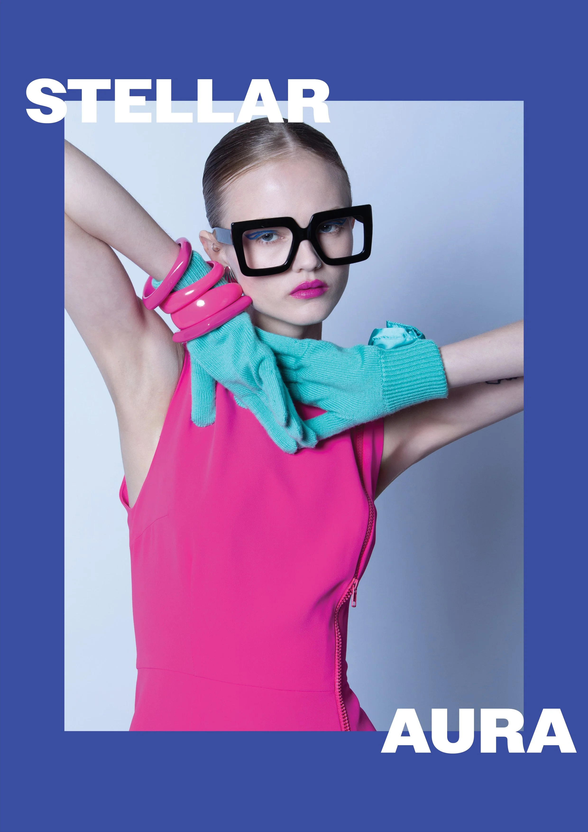 Fashion model wearing a pink sleeveless top, turquoise gloves and chunky black glasses, with pink bracelets, in a studio shot