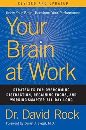 Book cover titled 'Your Brain at Work' by Dr. David Rock with a blue background and yellow text, featuring a radiant burst pattern.