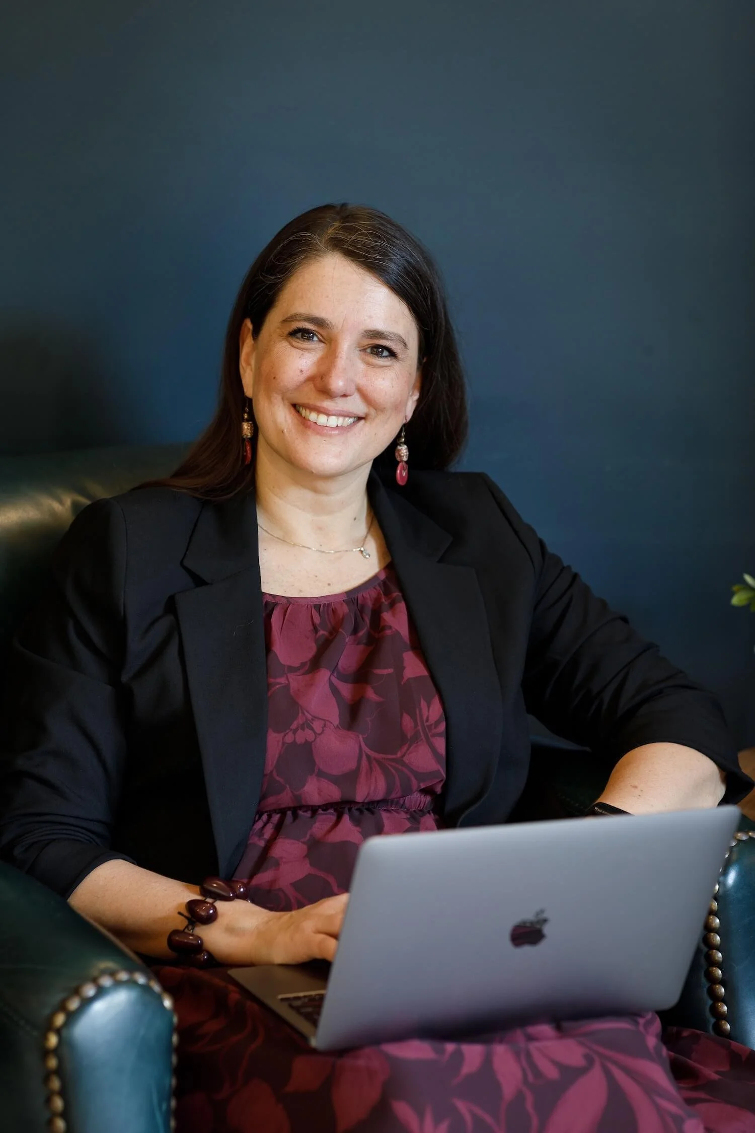 Clara Moisello, PhD, working at a laptop, bringing neuroscience and empathy to communication training