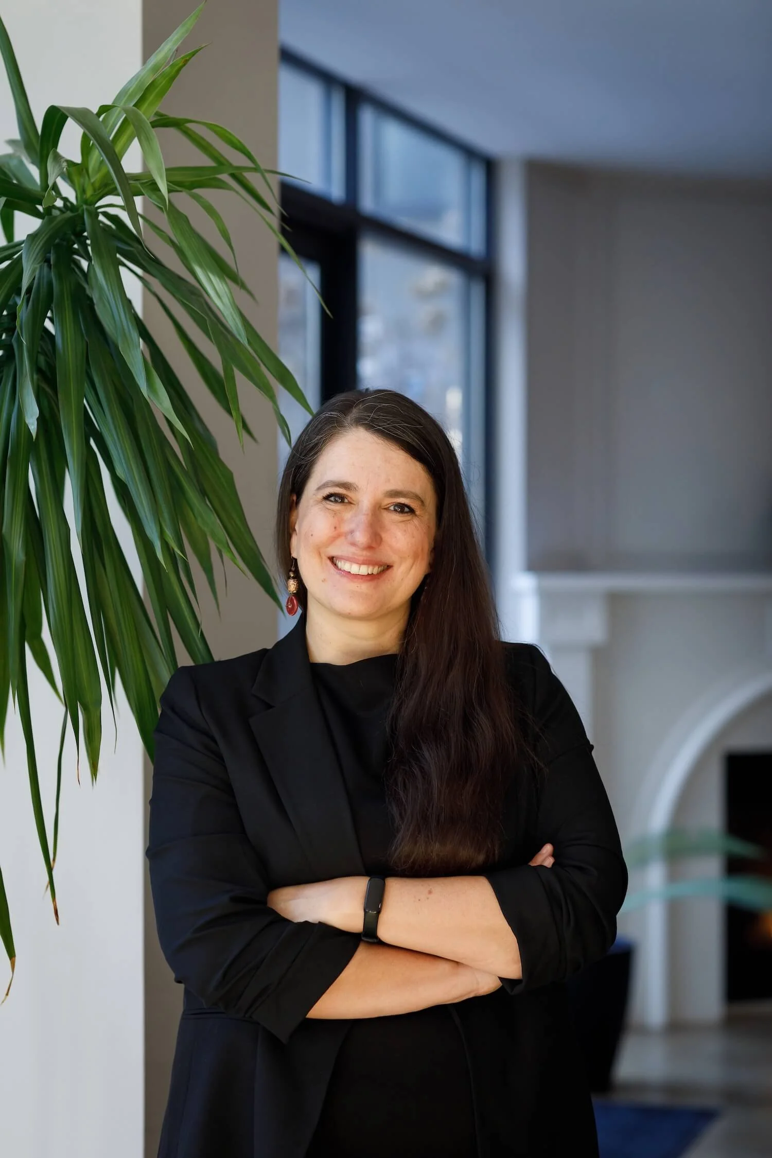 Clara Moisello, PhD, organisational consultant and leadership communication trainer, arms folded and smiling