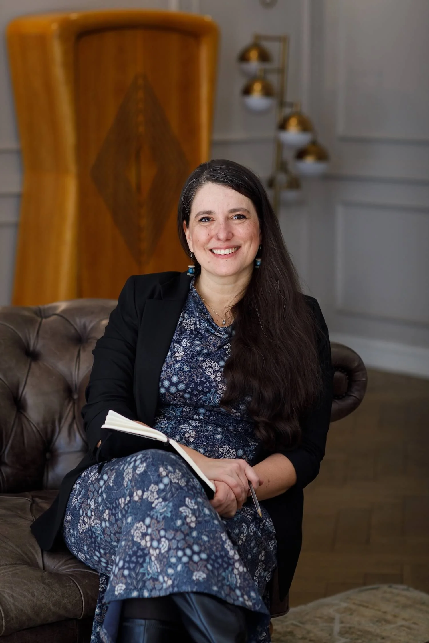 Clara Moisello seated in a relaxed pose, NVC trainer and organisational communication consultant