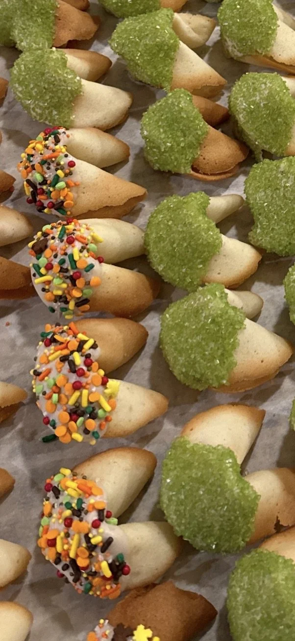Assorted cookies with green sugar crystals and colorful sprinkles on some.