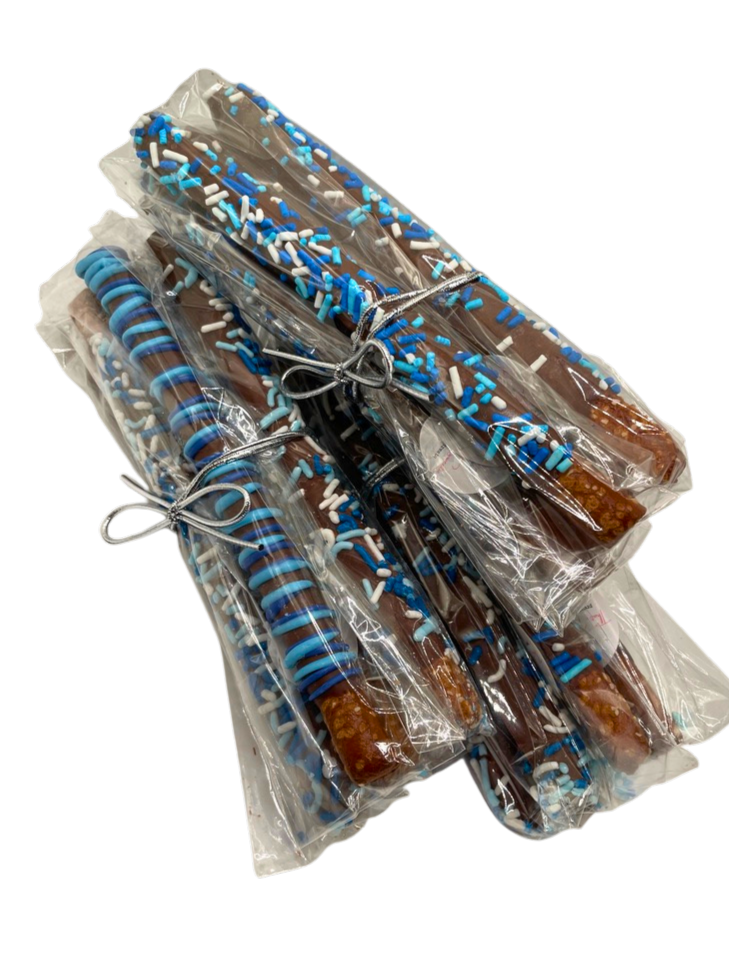 Multiple chocolate-covered pretzels decorated with blue and white sprinkles, individually wrapped in clear plastic and tied with silver ribbons.