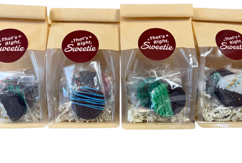 Four gift boxes containing decorated cookies with cookies inside clear plastic wrapping, labeled 'That's Right, Sweetie' in a burgundy circle.