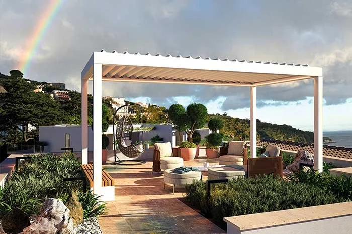 Rooftop terrace with outdoor seating, a hanging egg chair, potted plants, and a rainbow in the cloudy sky.
