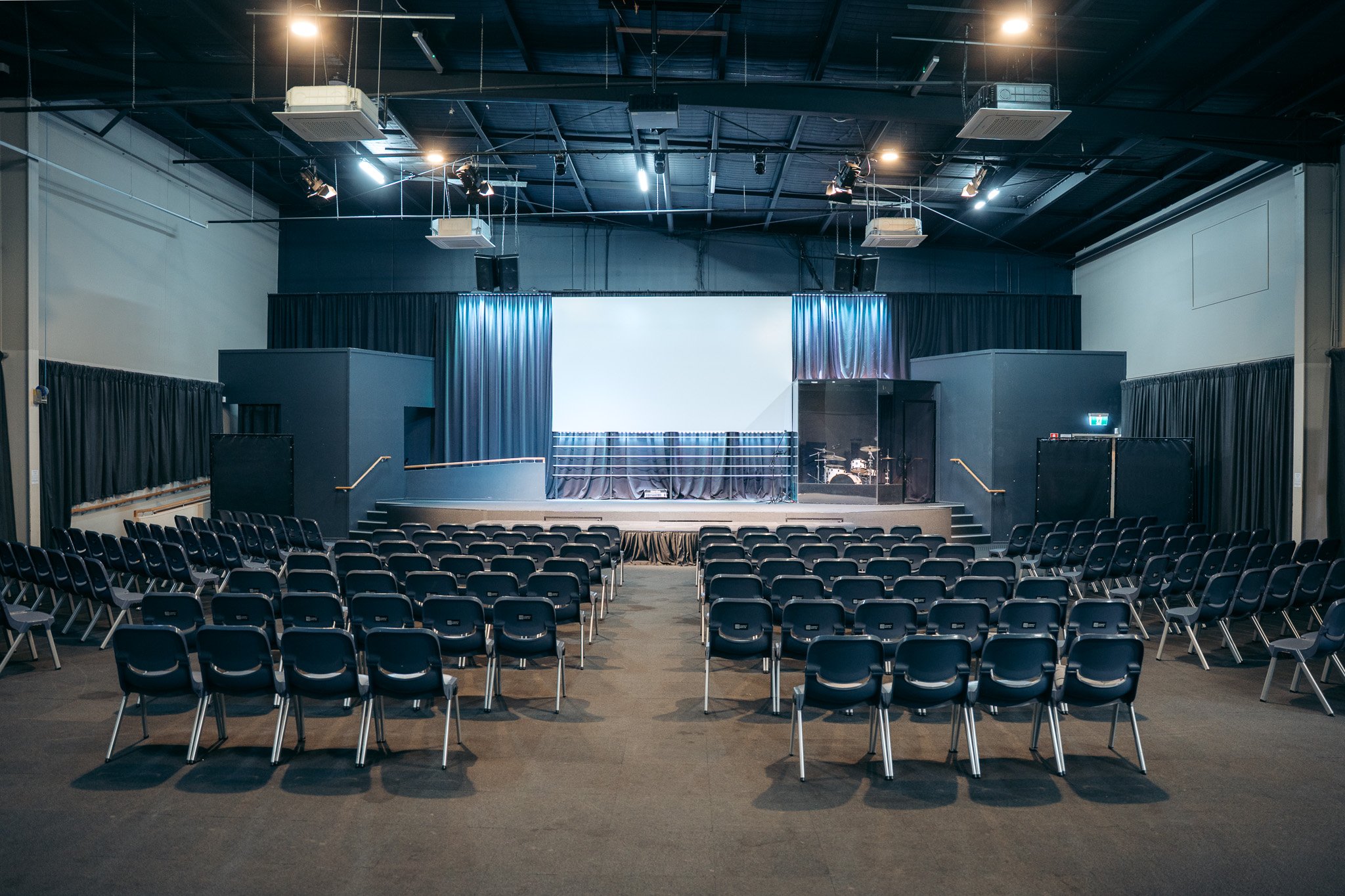 Large event venue in Caloundra with stage, seating and presentation screen, available for conferences, events and gatherings on the Sunshine Coast.