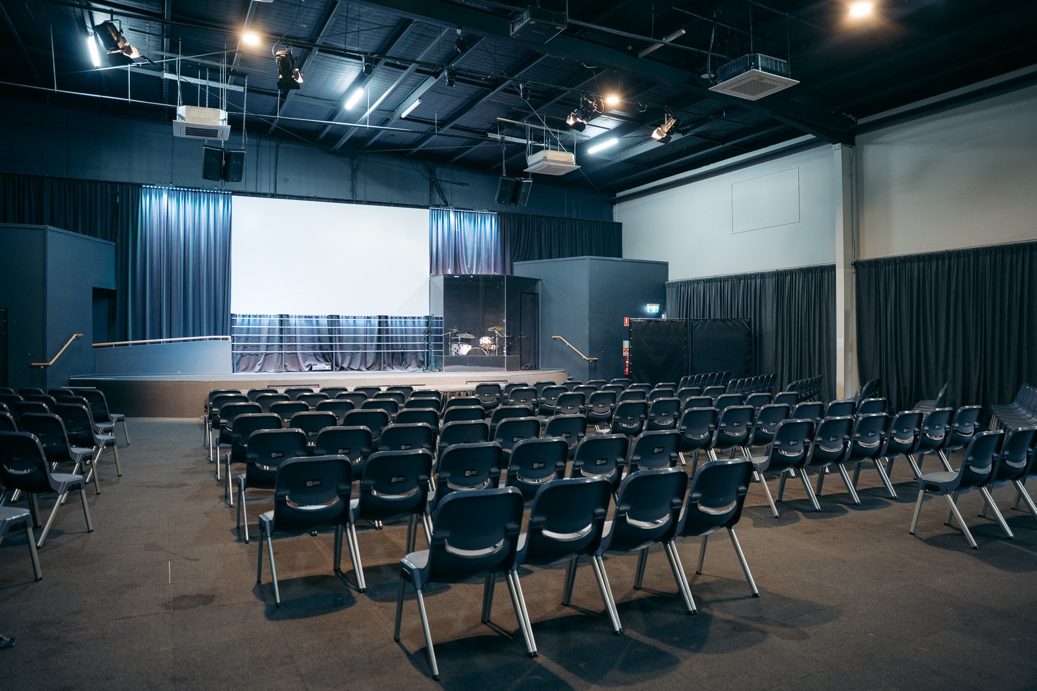 Large event space for hire in Caloundra with stage, seating and presentation screen, available for conferences, events and community gatherings on the Sunshine Coast.