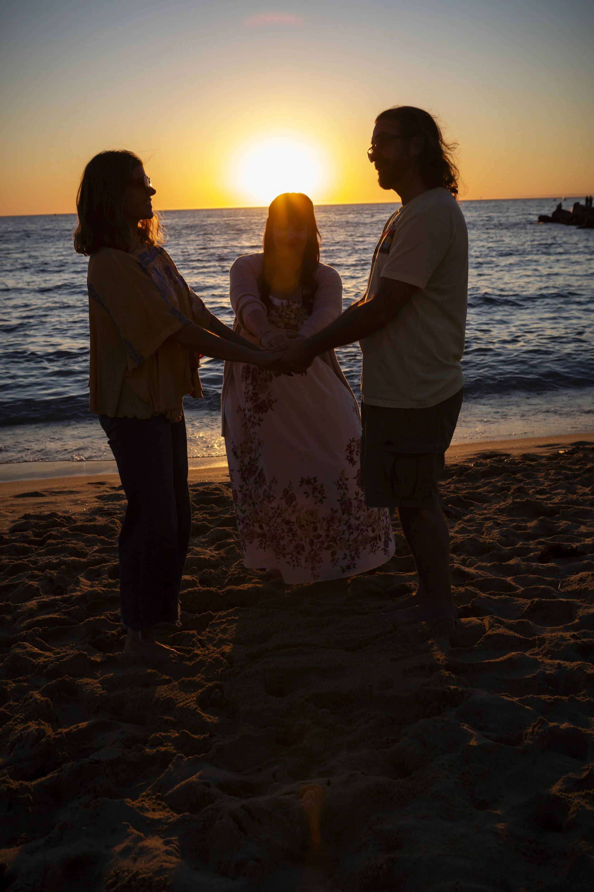 A couple and infidelity therapist on the beach, symbolizing affair recovery and healing during a marriage retreat.