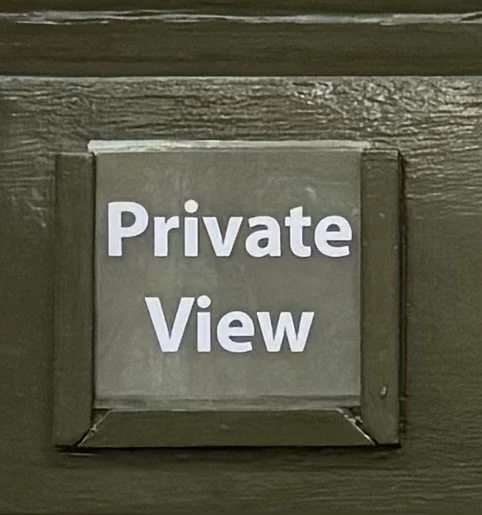 A sign on a wooden surface that reads 'Private View' in white letters.