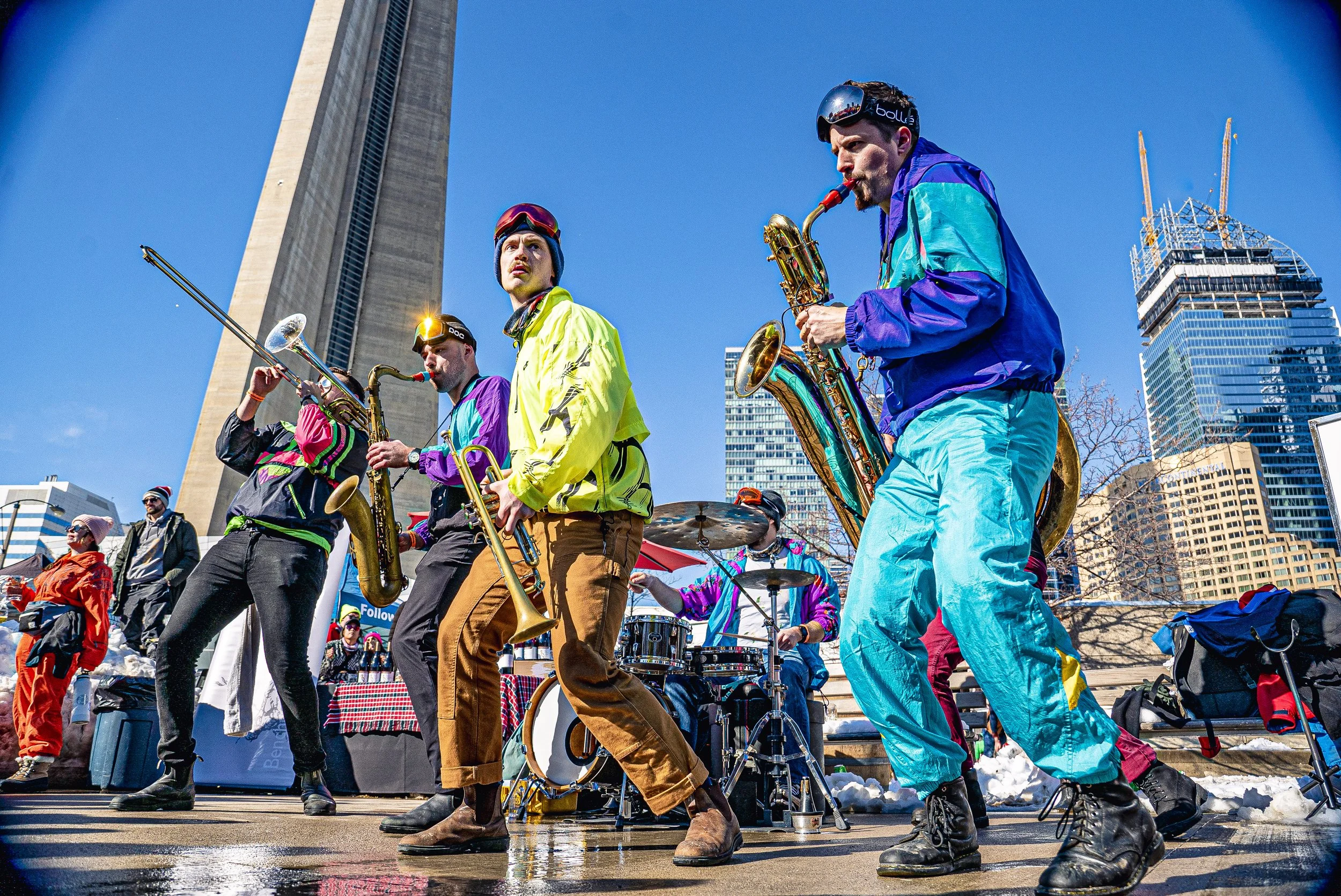 Big Smoke Brass playing an outdoor set at Steam Whistle with the CN Tower in the background. The band is dressed for the occasion - in apres ski attire.