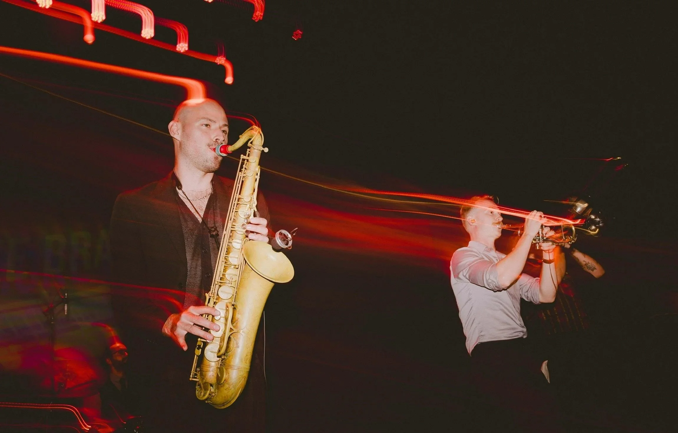 A photo focusing on the Tenor Saxophone and Trumpet players.