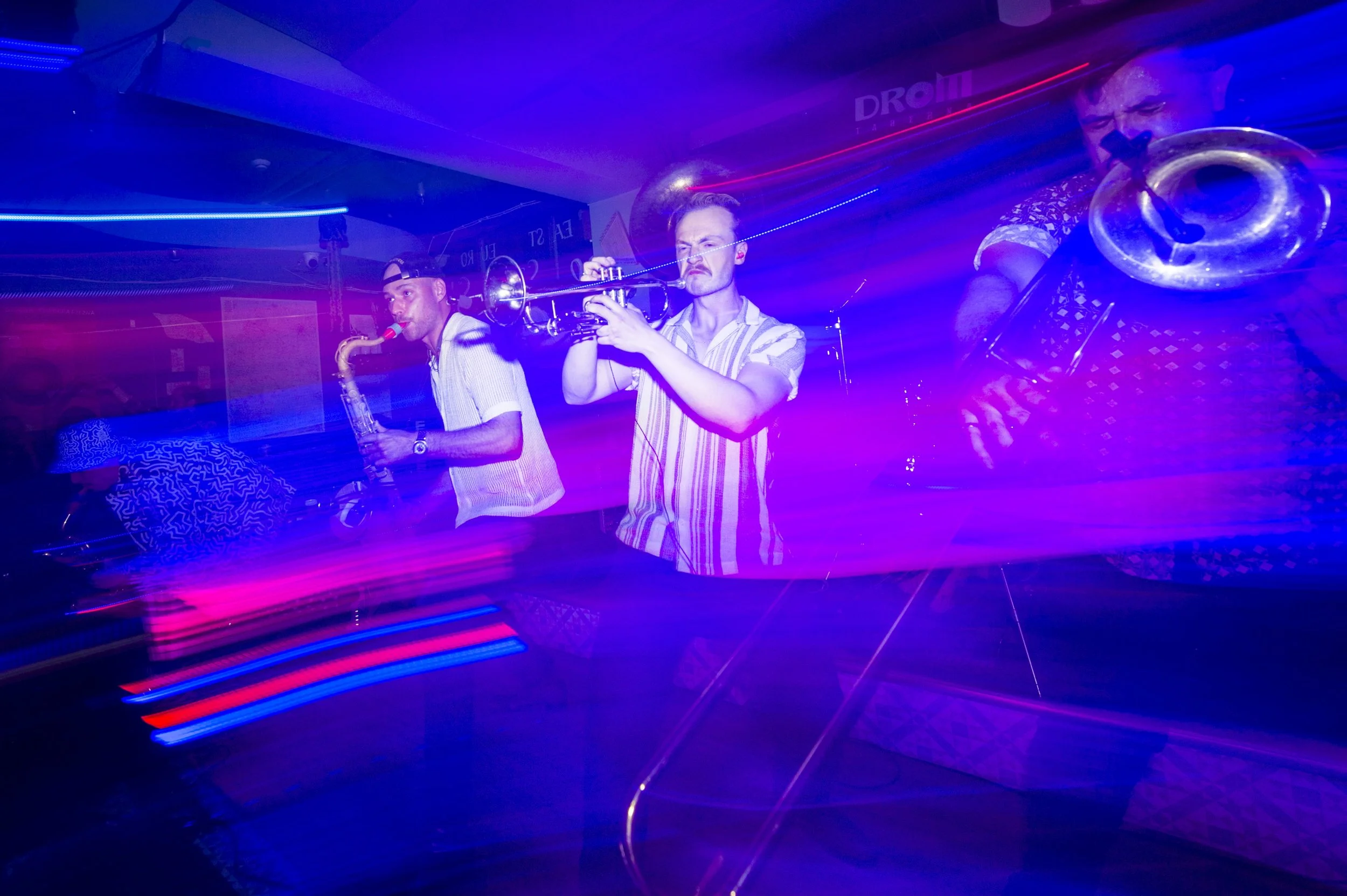 Motion blur and flash used to show how exciting Big Smoke brass is on stage.