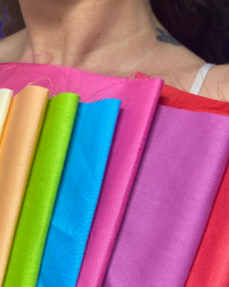 Colored fabric or cloth in yellow, green, blue, pink, and red shades.