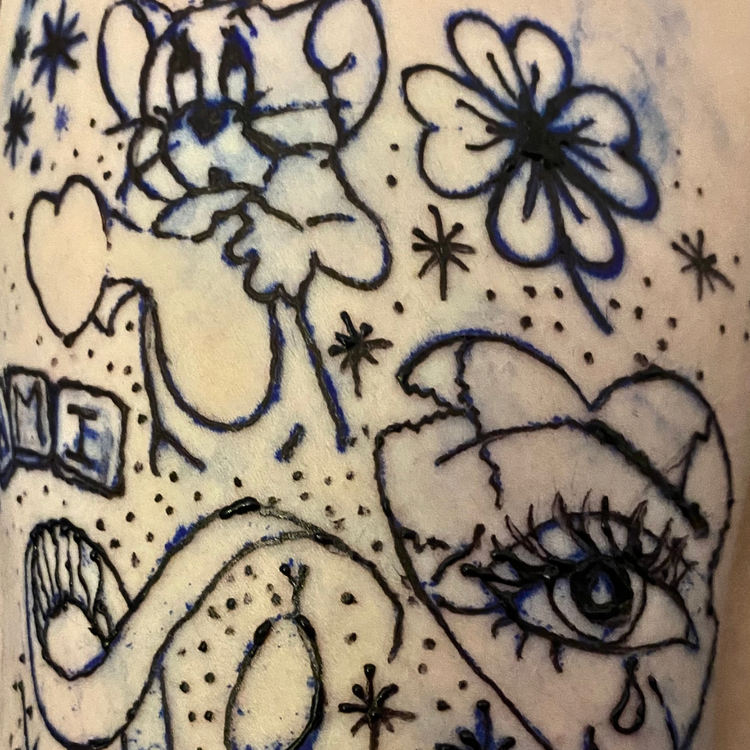 Drawing of a cat and a dog surrounded by flowers, hearts, stars, and dots, with various decorative elements.