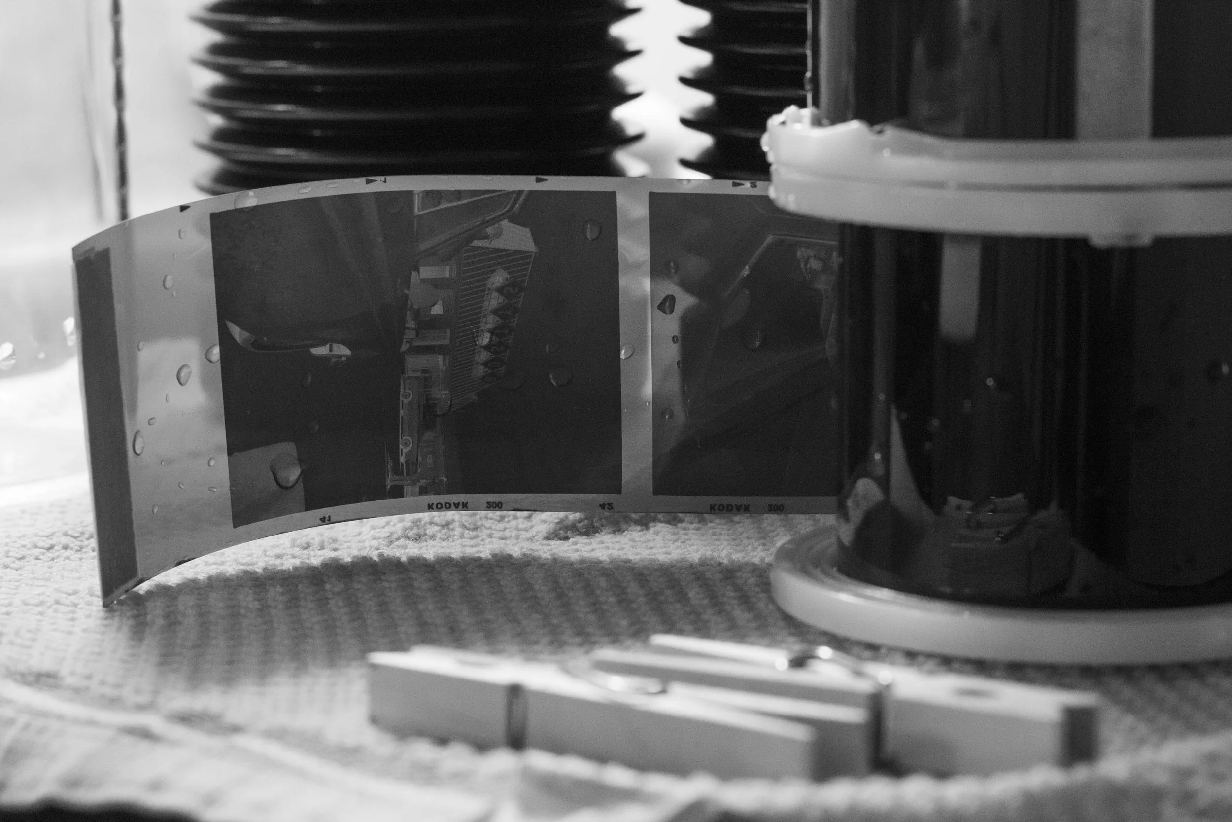 Close-up view of film negatives on a reel on the counter during development