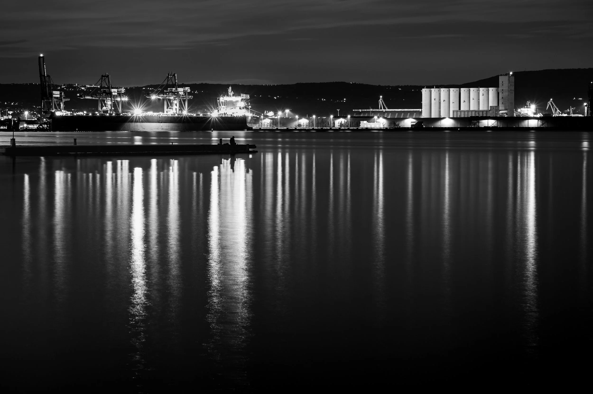 Long exposure reflections along the waterfront at night