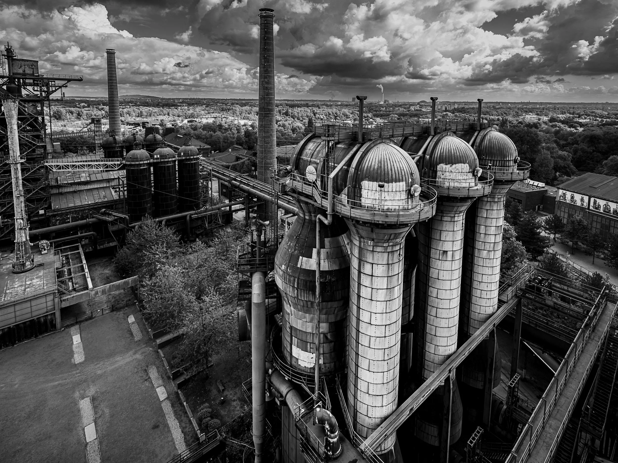 Historic blast furnace, gas holders and pipes rising above the Duisburg industrial landscape.