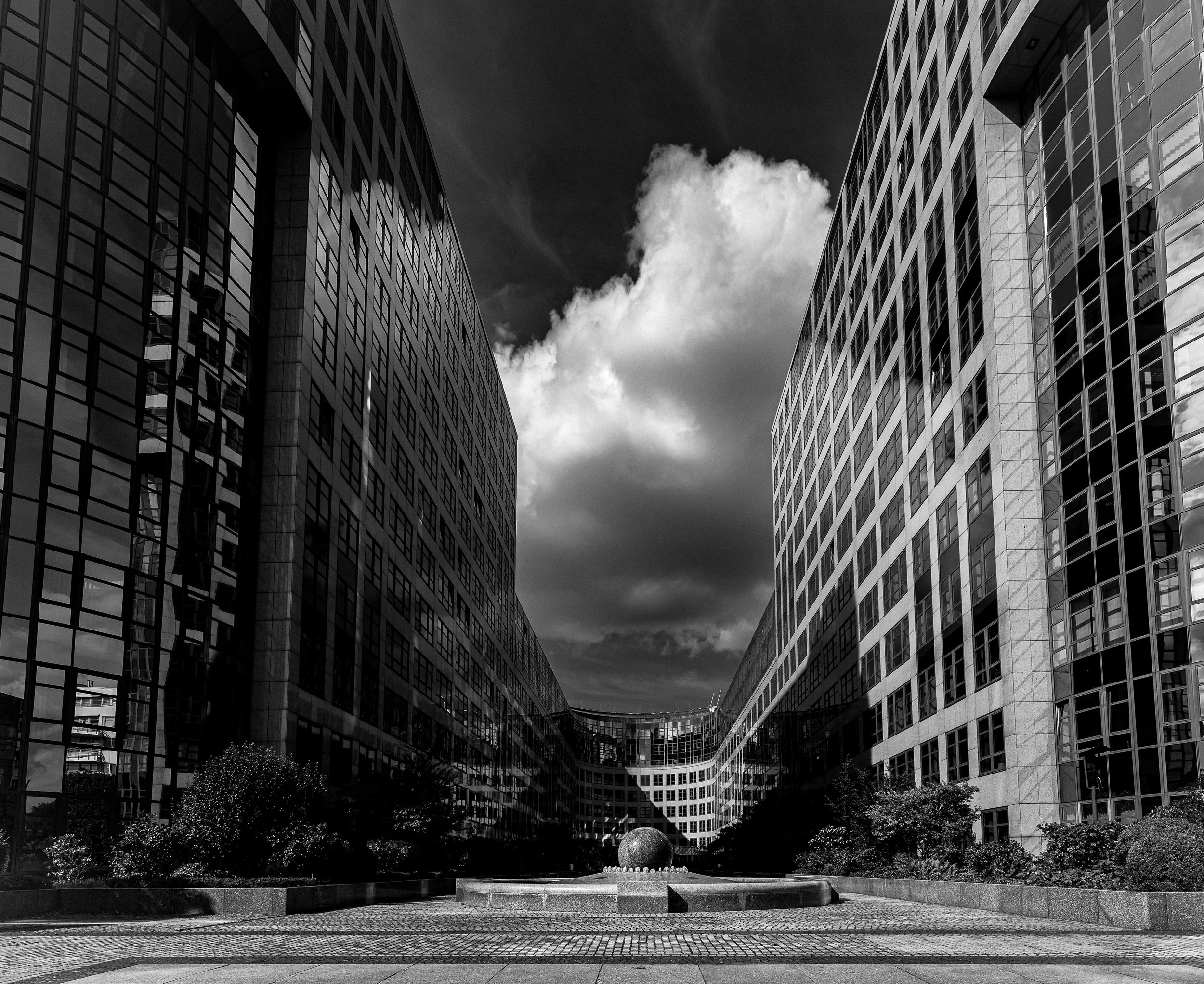 Modern architecture framed by clouds and reflected light